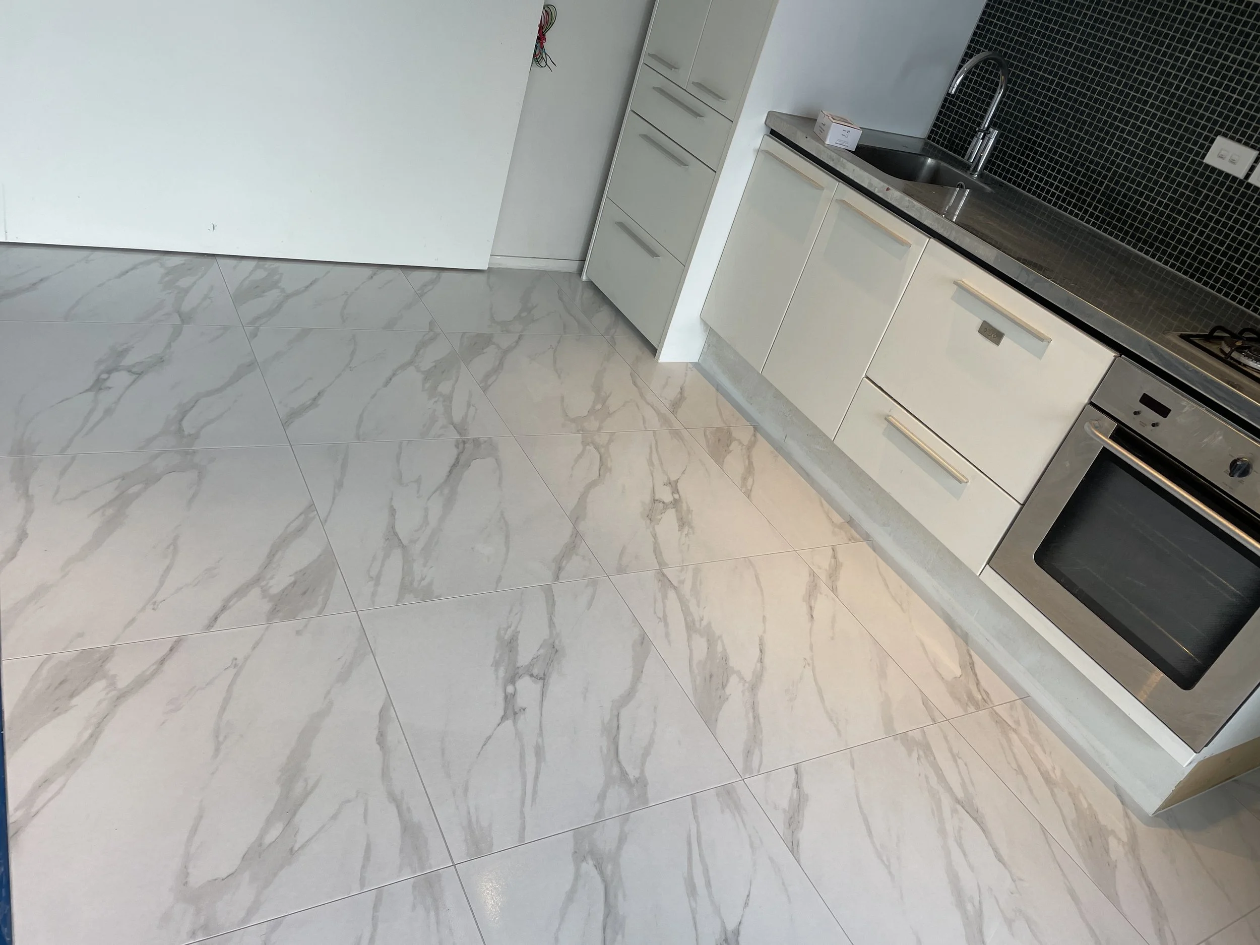 Tiles over underfloor heating cable. Job in Grey Lynn in 2023