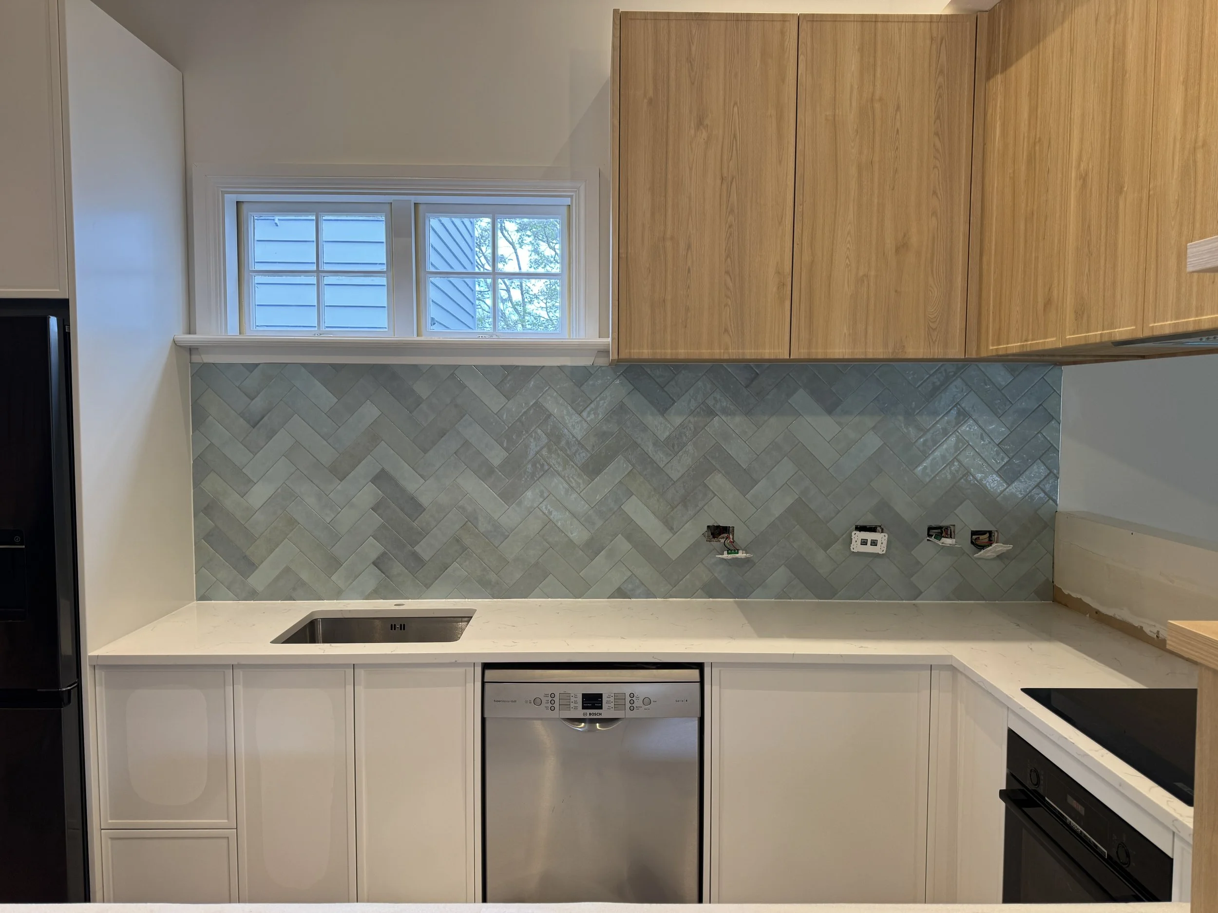 Herringbone with porcelain tiles done in Sandringham in 2025. Epoxy grout