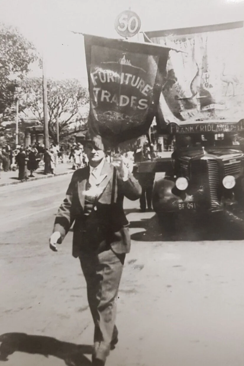 The smaller numbered metal disc was usually mounted above the bannerette of the union. Here we see the small bannerette of the Furniture Trades followed by their float (motor driven by this time) with the Union’s banner on display (this large banner…