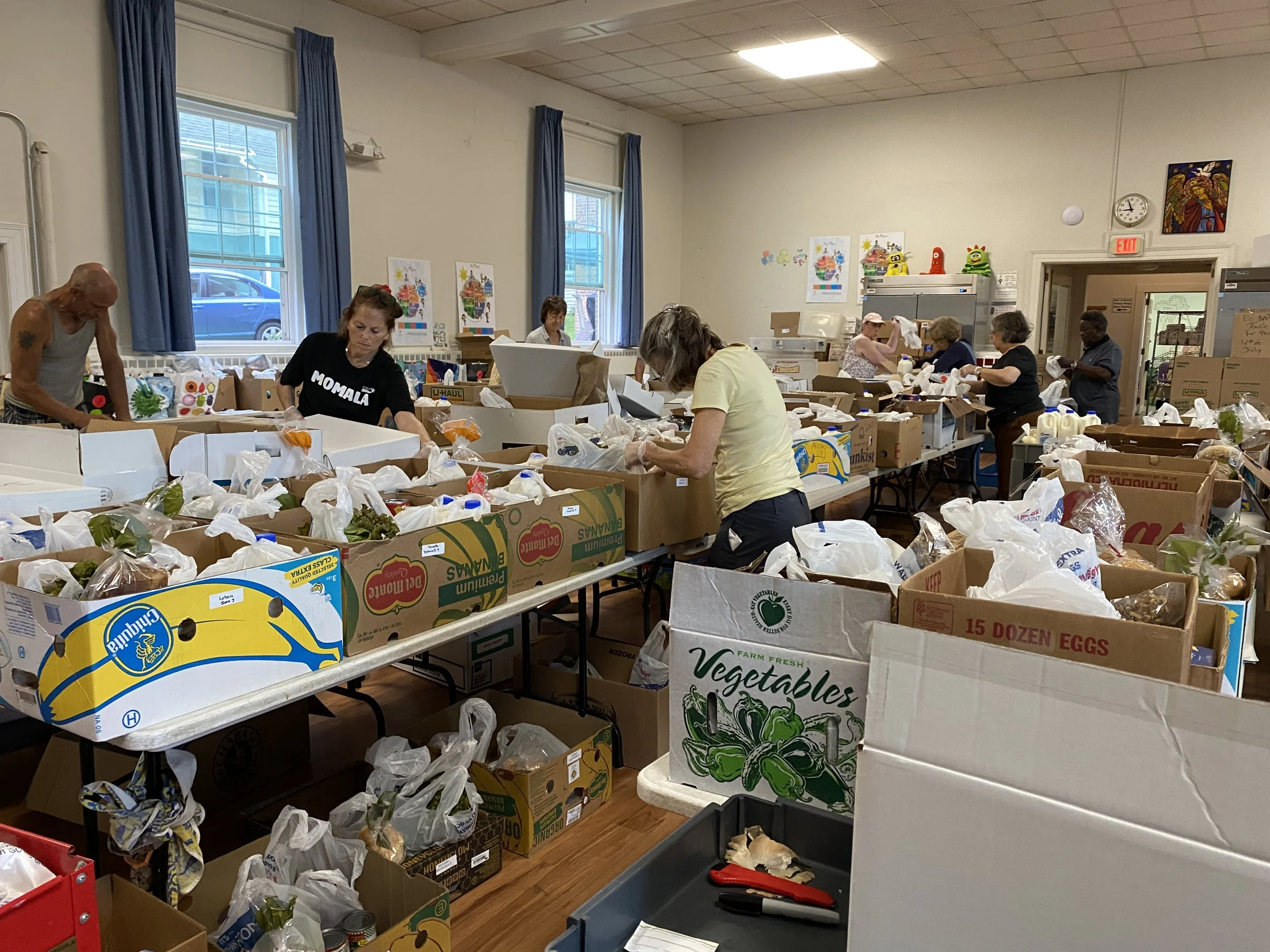 Volunteers preparing boxes of food for delivery to clients.JPG