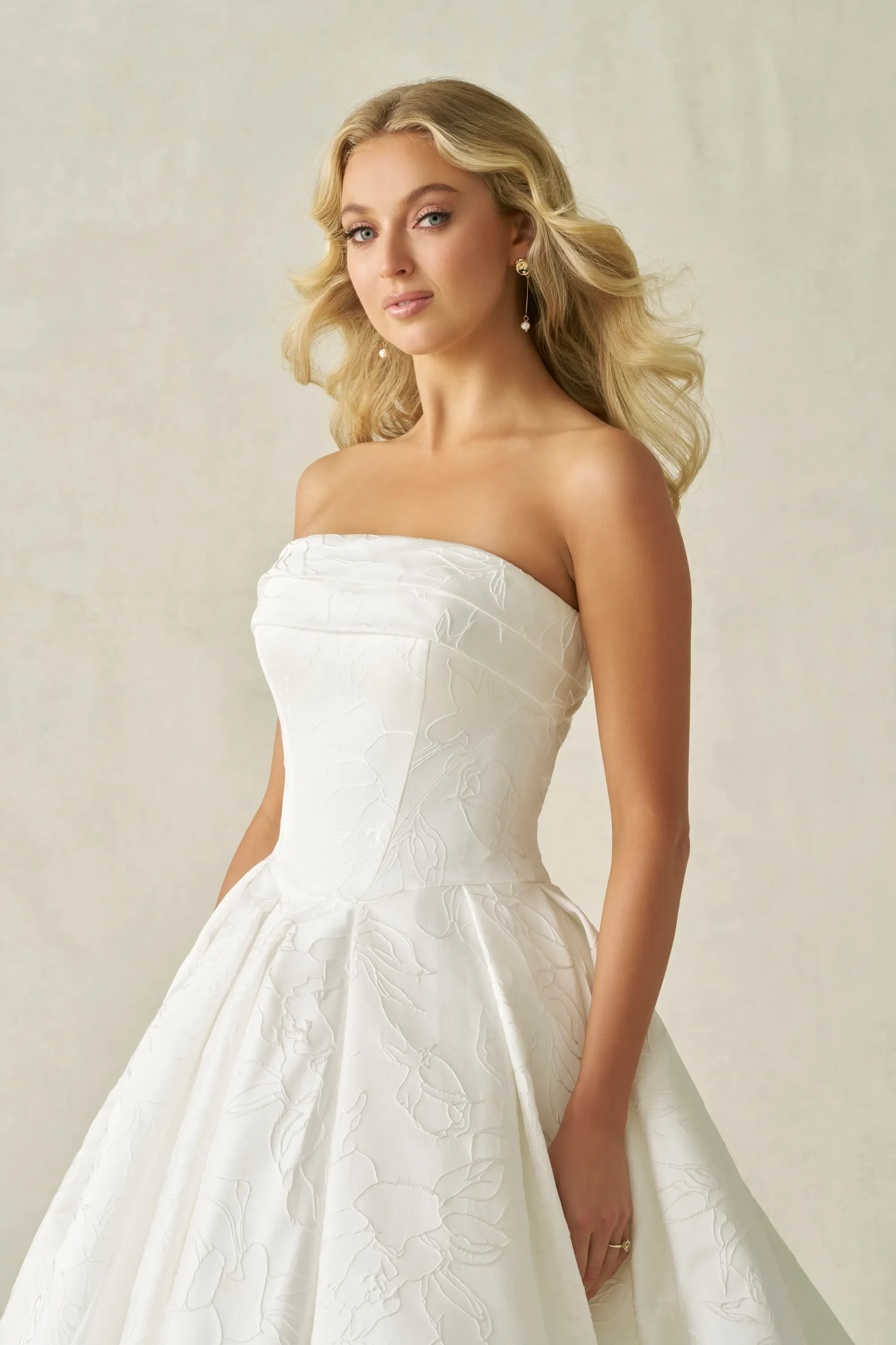 Bride looks beautiful with loose curls in her strapless wedding gown
