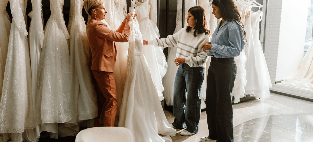 Bride and guests browsing wedding dresses during a personalized bridal appointment