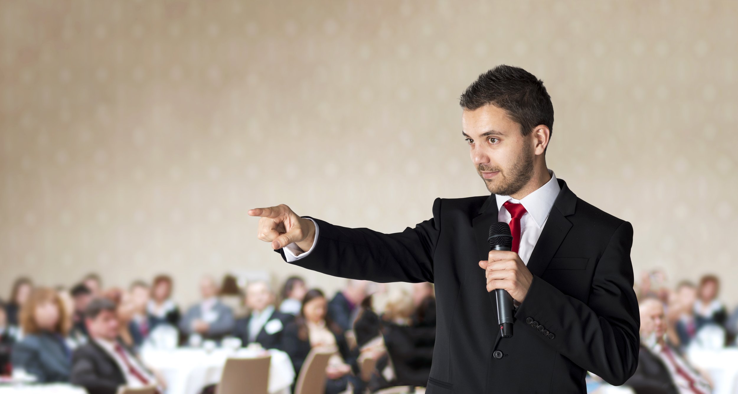Man Pointing in front of Audience_shutterstock_120239734.jpg