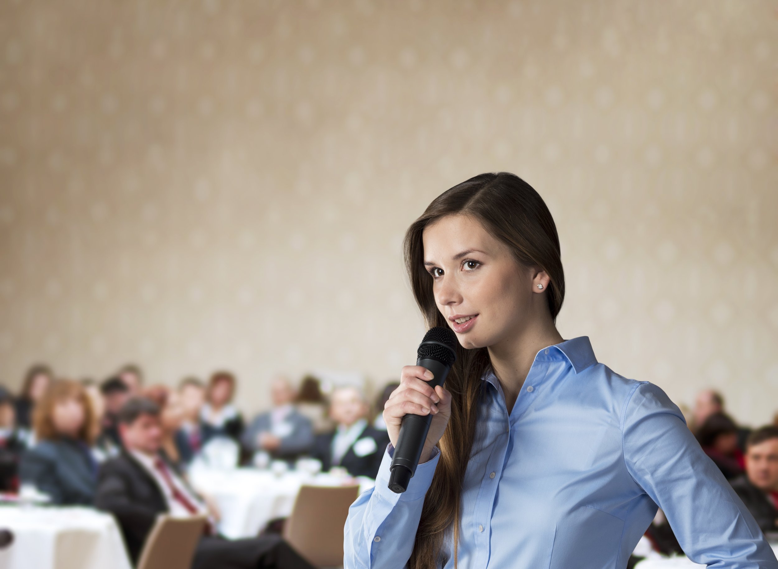 Woman Speaking via Mike to Audience_shutterstock_119921404.jpg