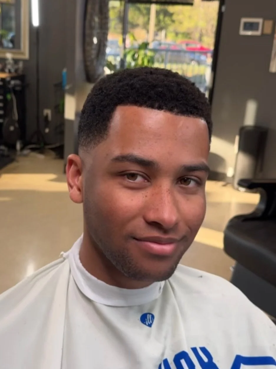 Dialed in from every angle.

Smooth blend on the sides with a crisp lineup to finish&mdash;balanced, clean, and built to last.

In Herndon, VA or around the NoVA area? Stop by or book with us. We offer haircuts, beard trims, locs services, and more.
