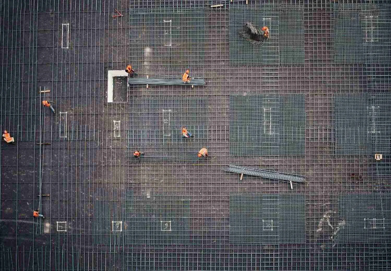 Independent monitoring surveyor inspecting construction site progress for lender compliance
