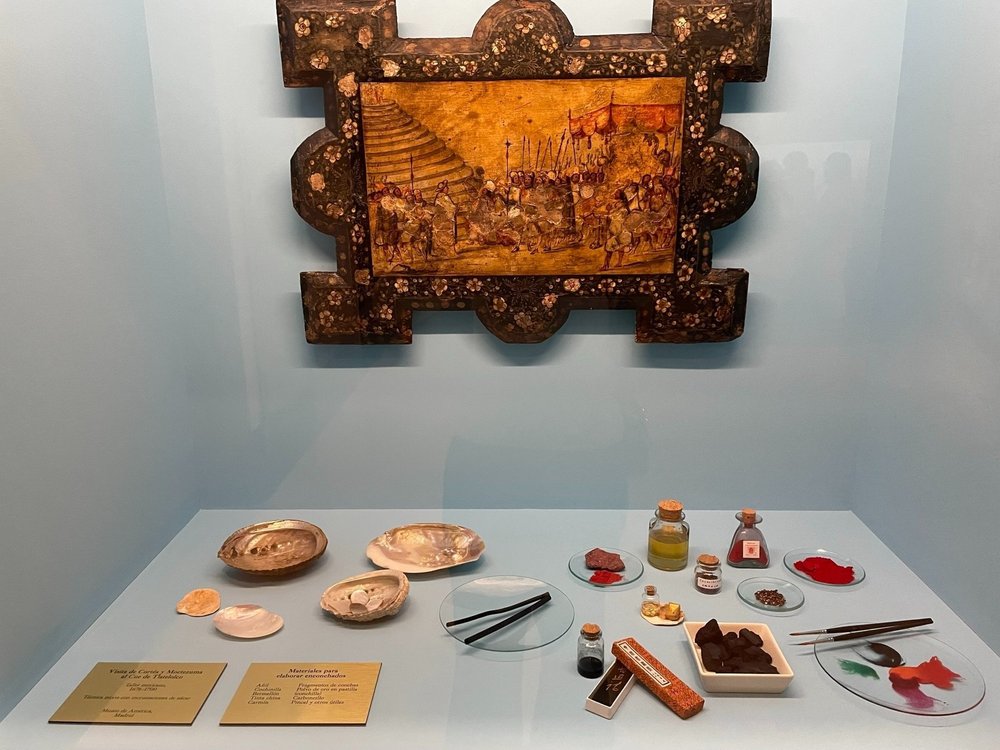 Materials and tools used in the production of enconchados like the one in this display.