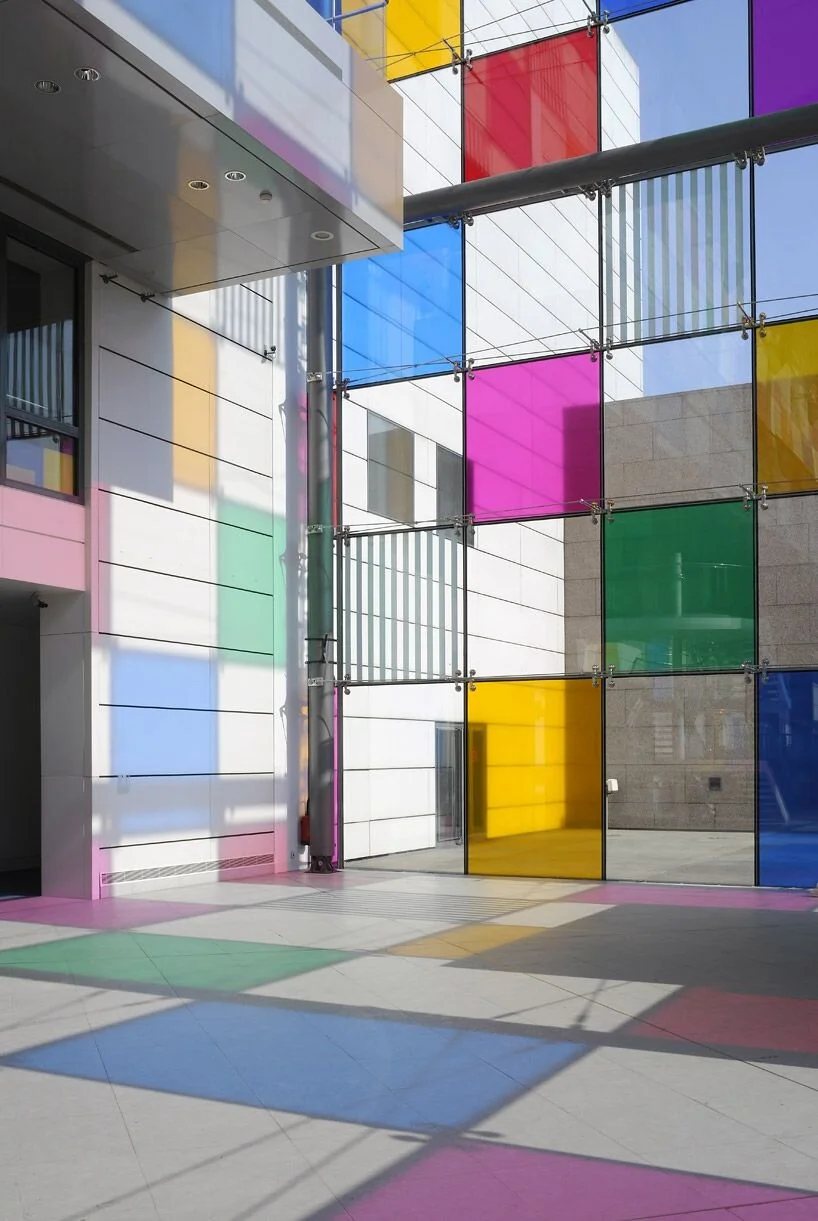 daniel buren adds tinted squares to colorize MAMCS' glazed facade.jpeg