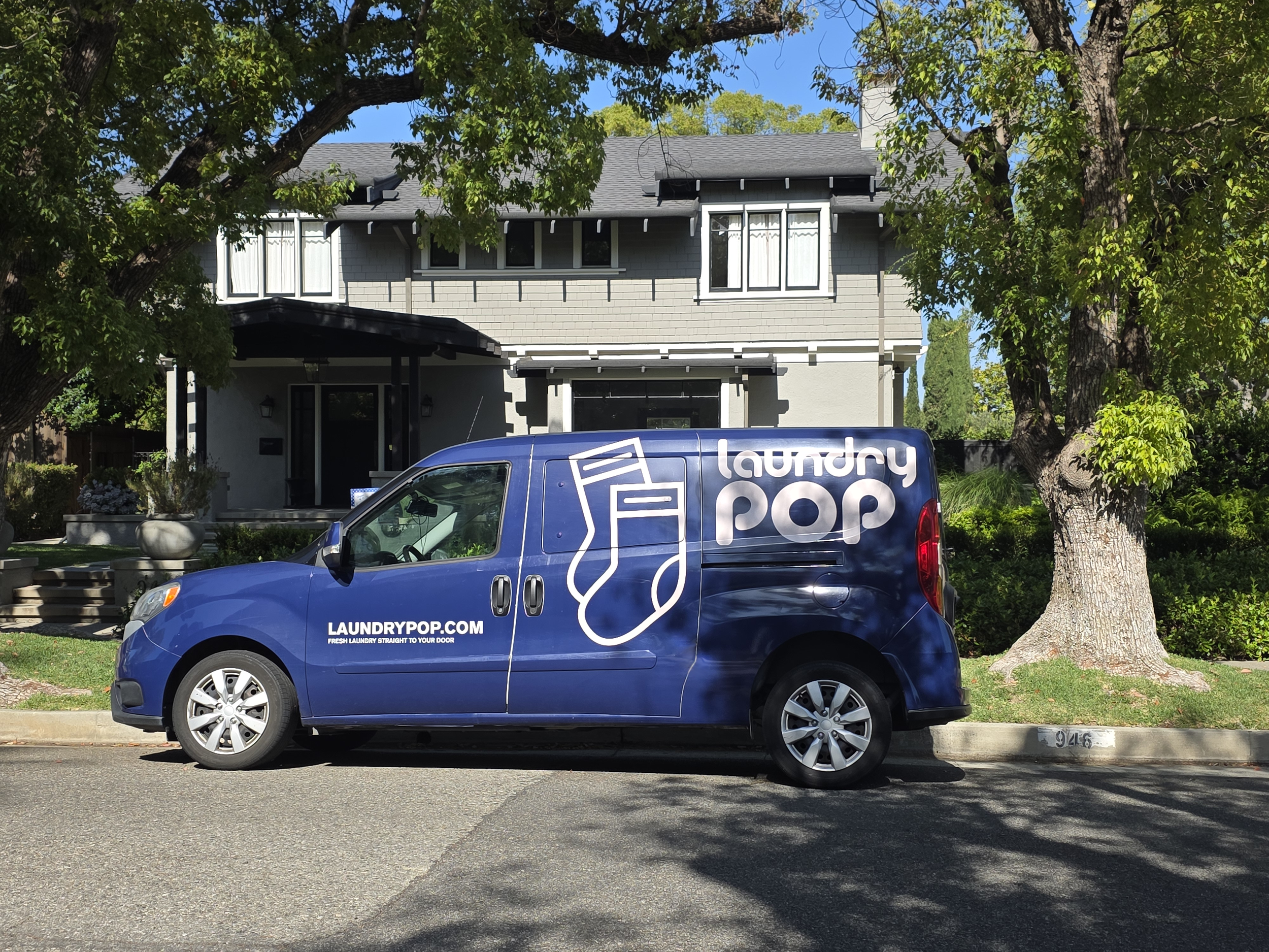 Laundry Pop delivery van parked outside a home in Los Angeles for laundry pickup