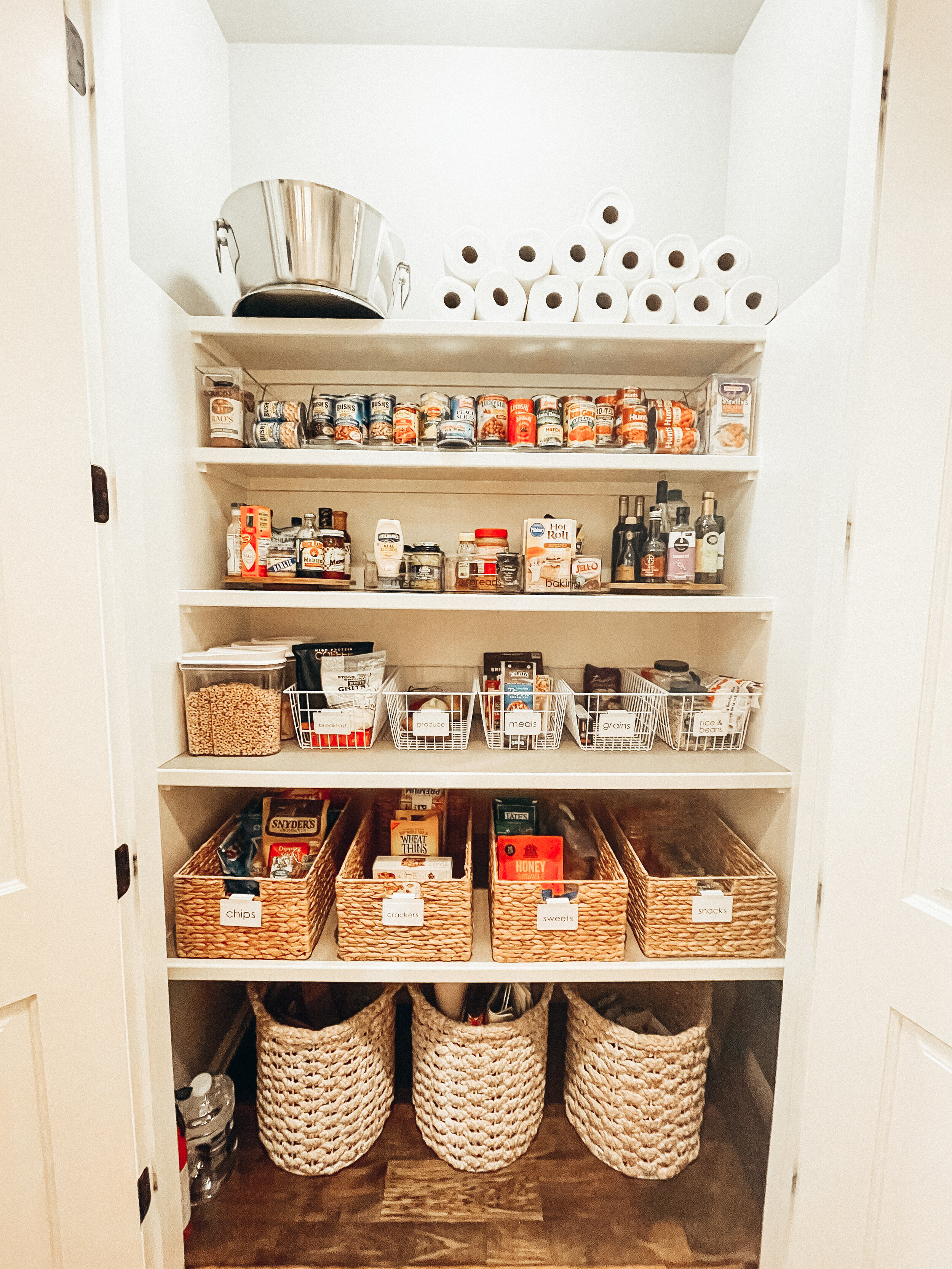 Pantry organized with woven baskets by Stay Golden Organizing