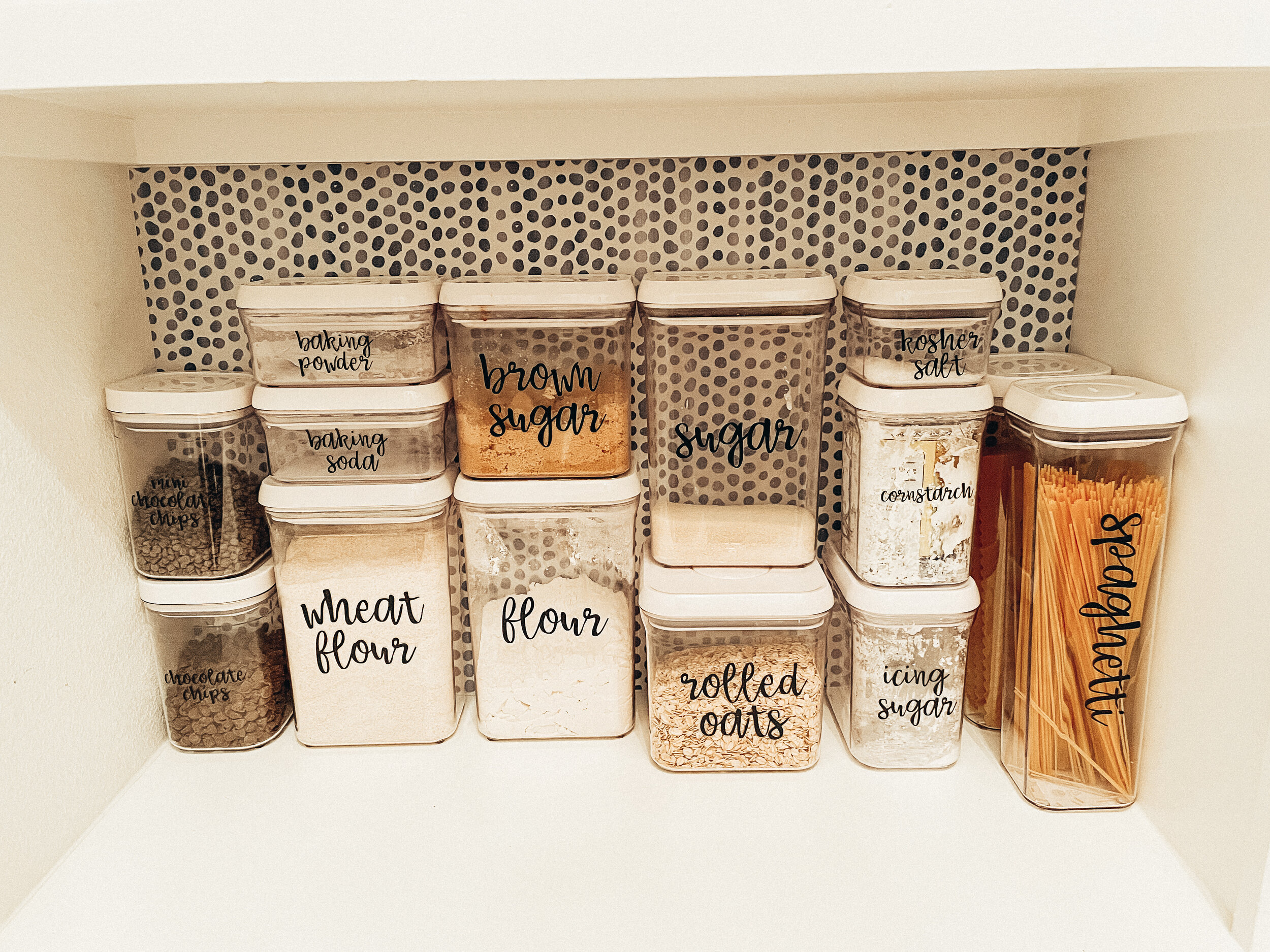 Organized pantry with baking supplies in clear containers