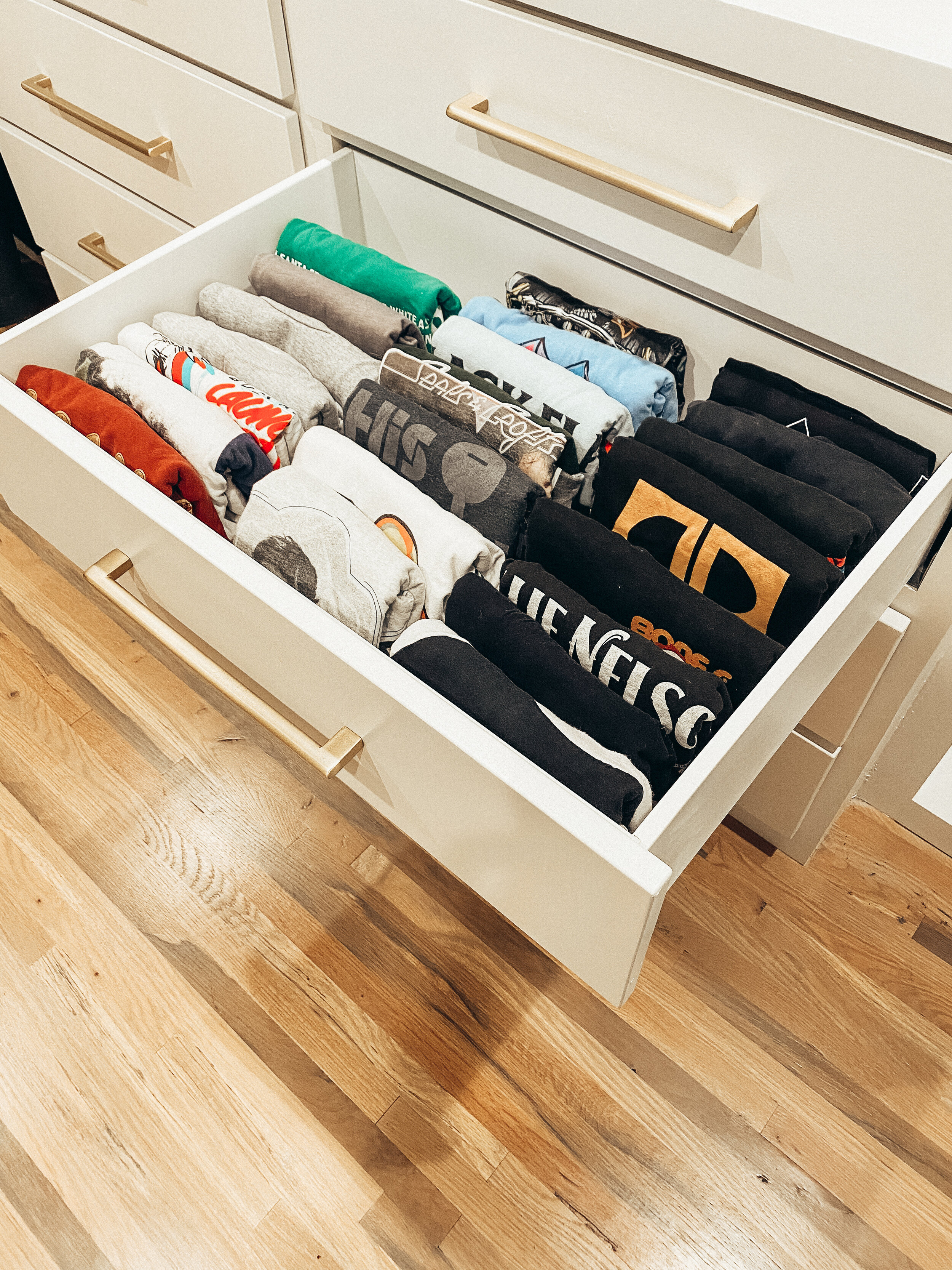 Clothing drawer organized with stacked folded shirts