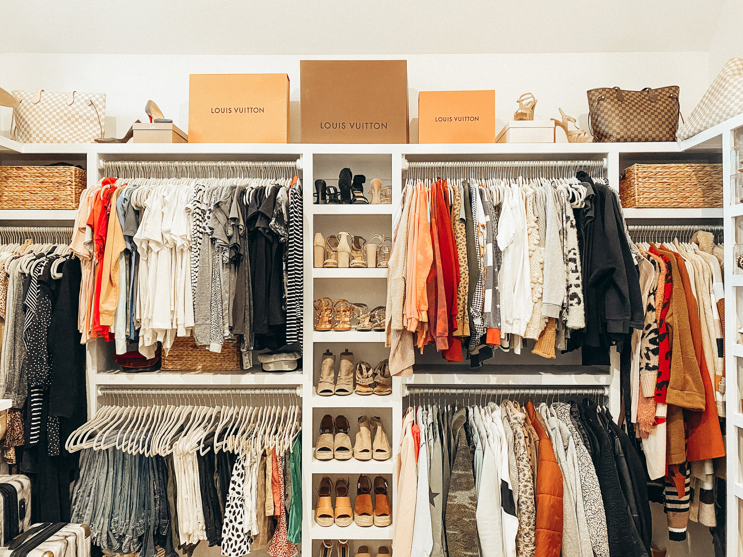 Organized closet with shelves and hanging clothes by Stay Golden Organizing