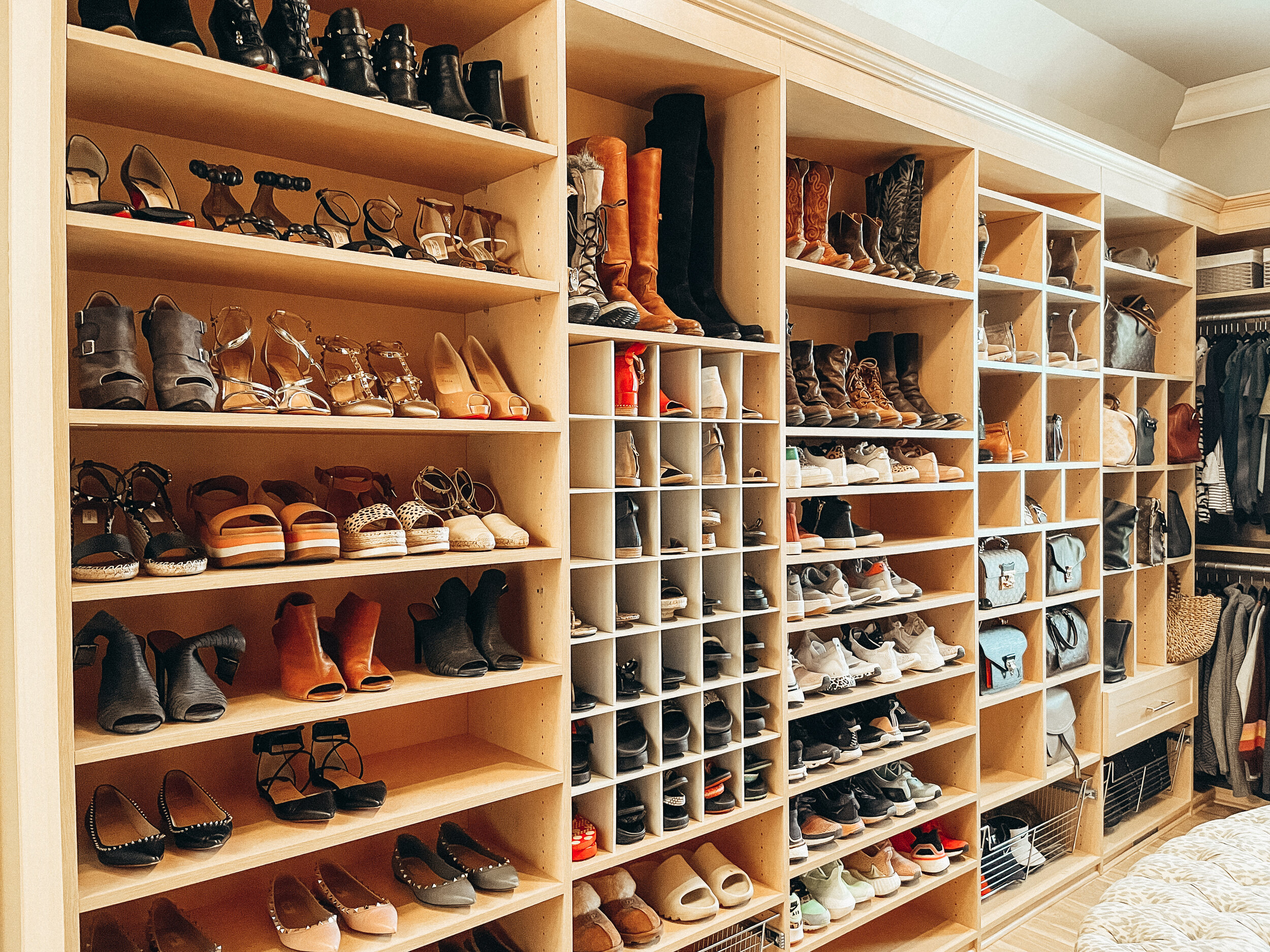 Large closet of shoe shelves organized by Stay Golden Organizing