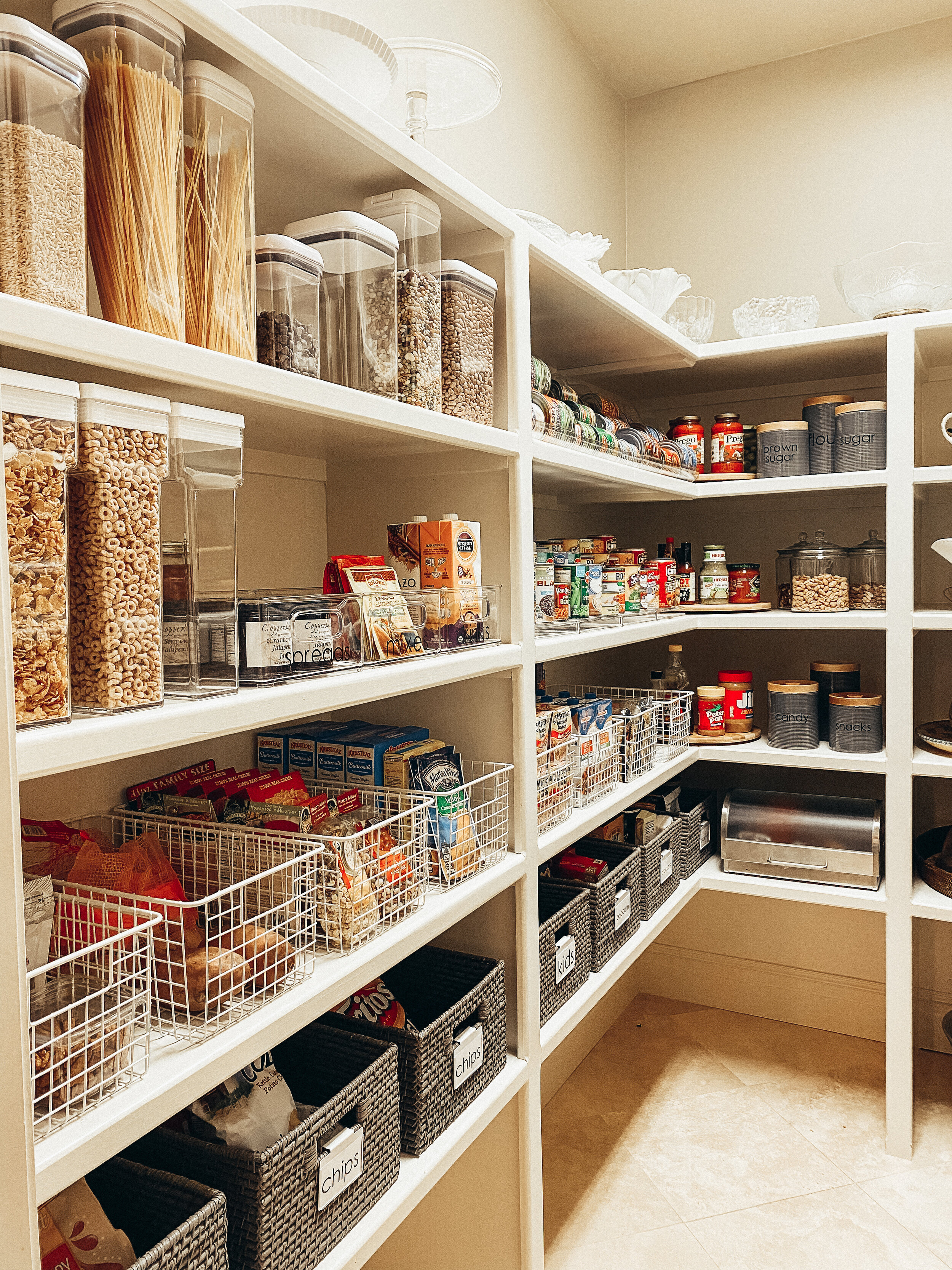 Large pantry organized with wire baskets and clear containers