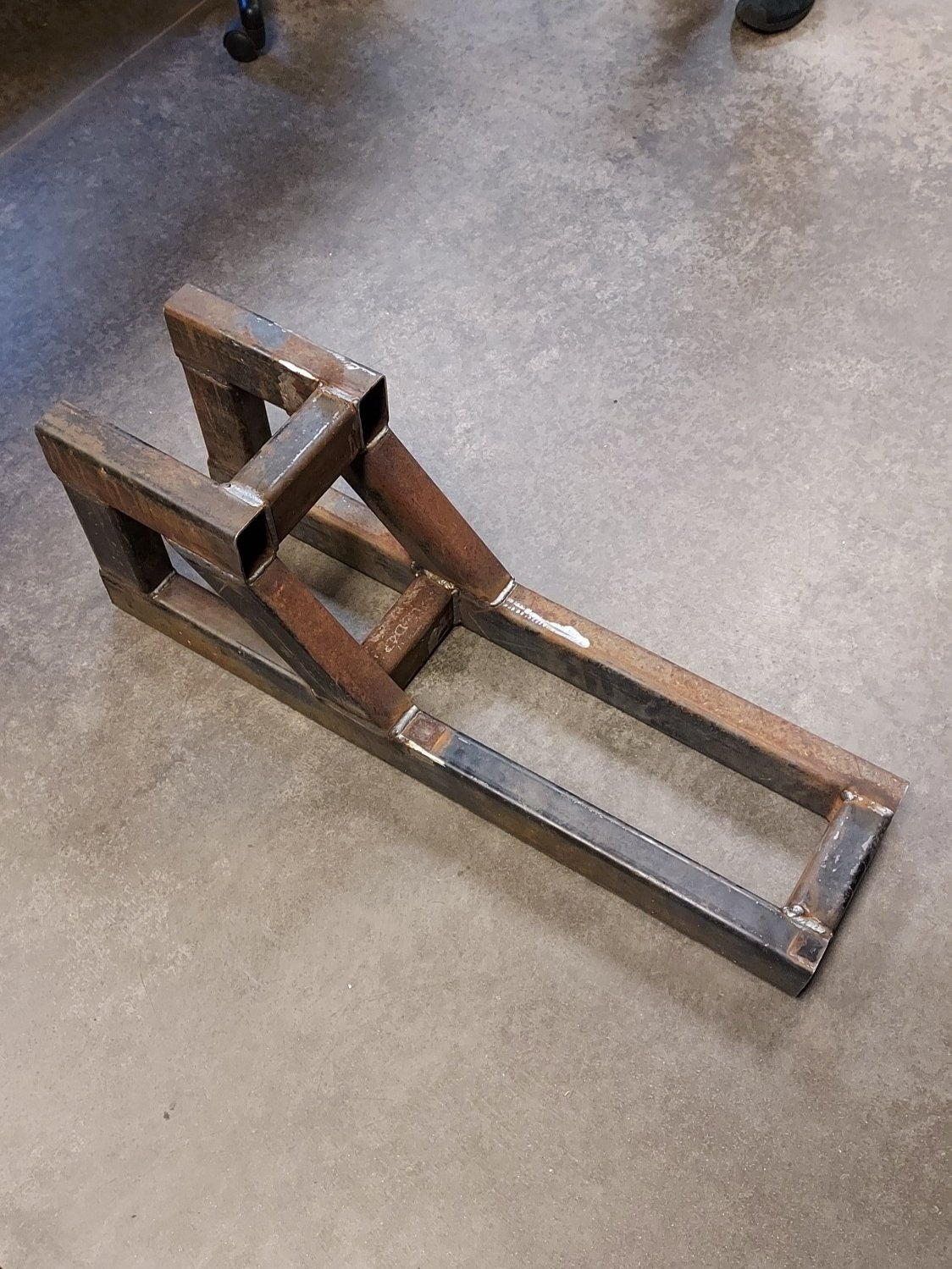 Fully welded support structure, not including the mounting plates for the engine or crushing mechanism.