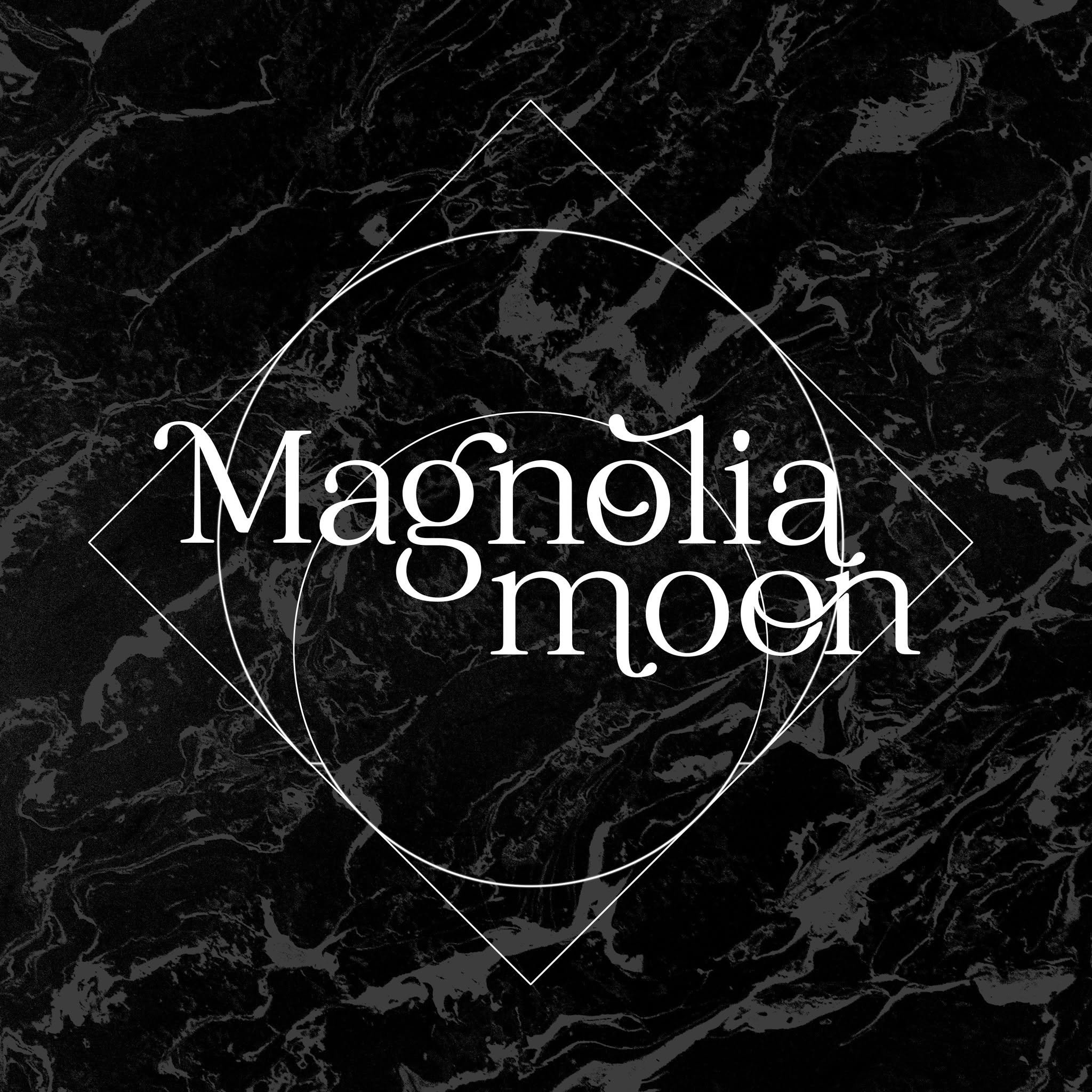 Close-up of words on a black marble surface with white text reading 'Magnolia.'
