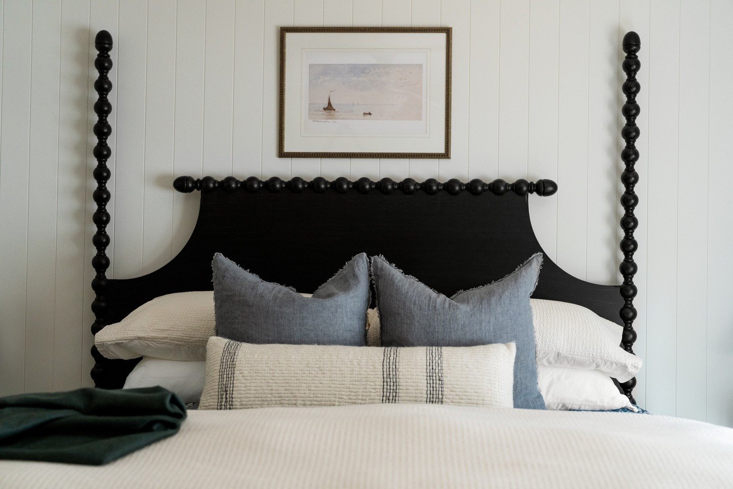 Coastal ease meets cabin inspired charm.

A closer look at this lake house bedroom.