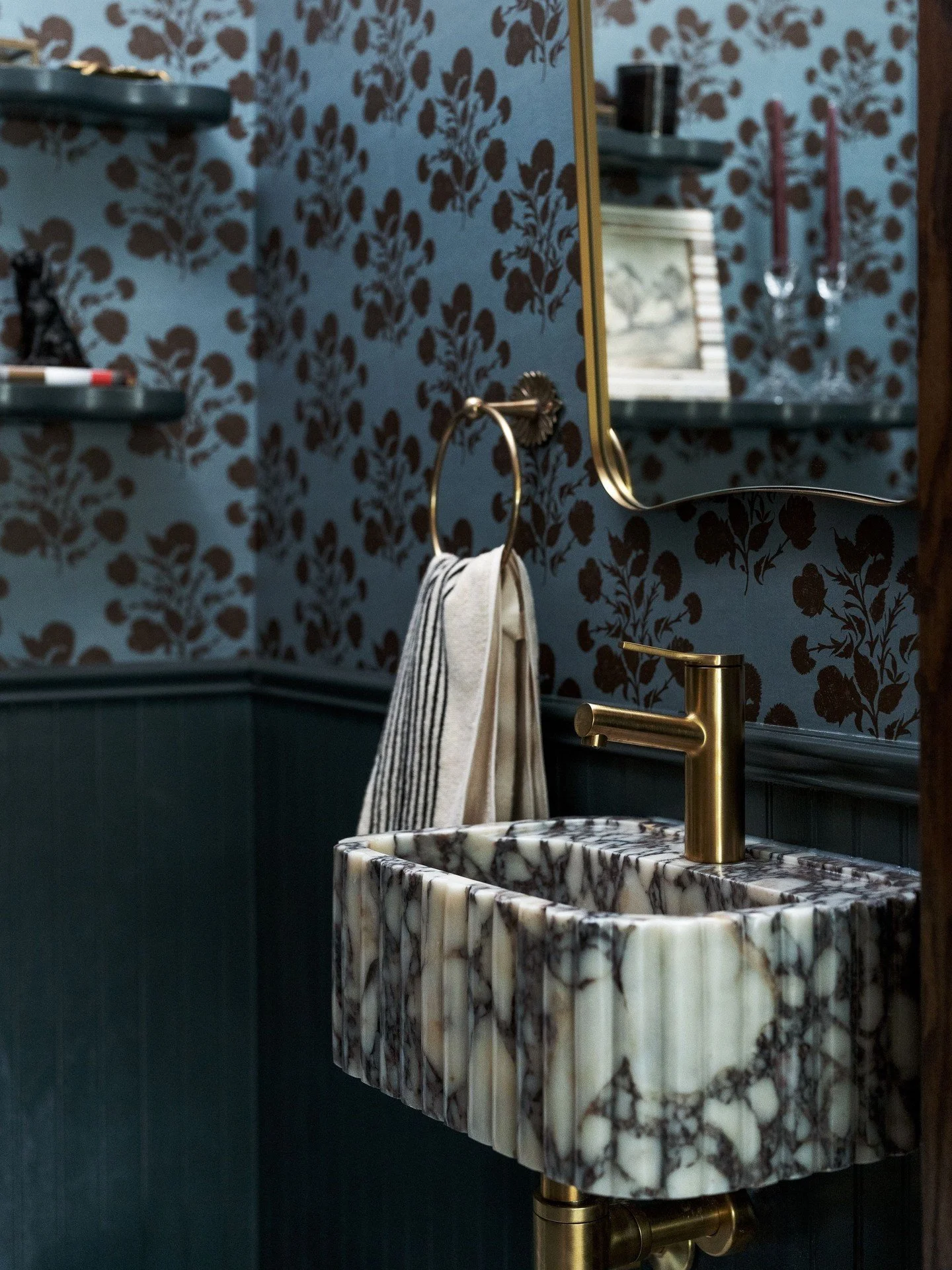 Still thinking about this sink.⁠
⁠
⁠
The shape, the stone, the aged brass. It brings just the right amount of character into this powder room.  Paired with the patterned wallpaper and checkerboard floor, it feels a little unexpected, in the best way.