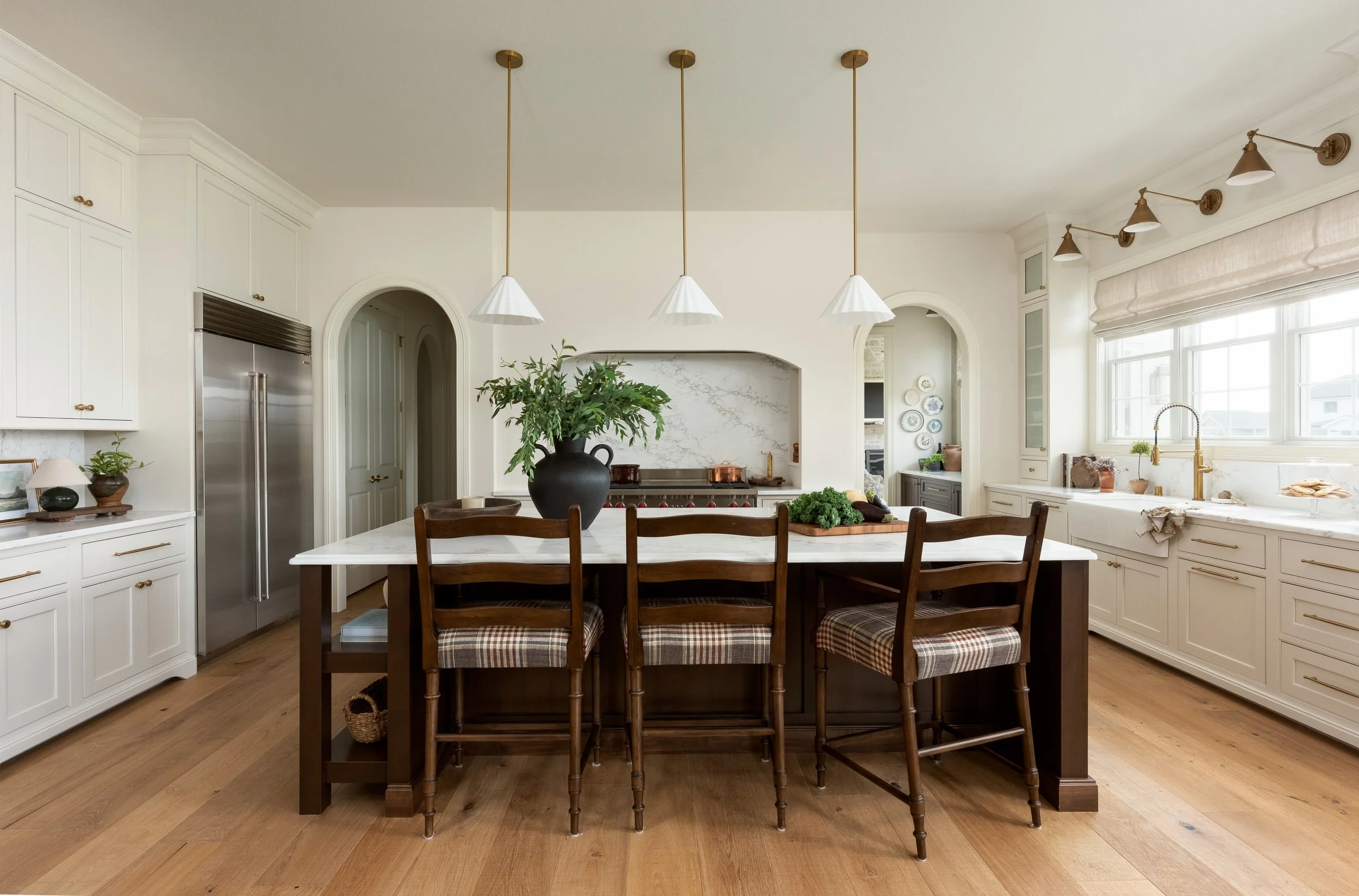 A new build with soul. 

That was the goal for Westbridge Estate, a new construction home in Waunakee. 

We layered traditional architectural details with natural stone, warm wood, vintage-inspired furnishings, custom upholstery, pattern, and plenty 