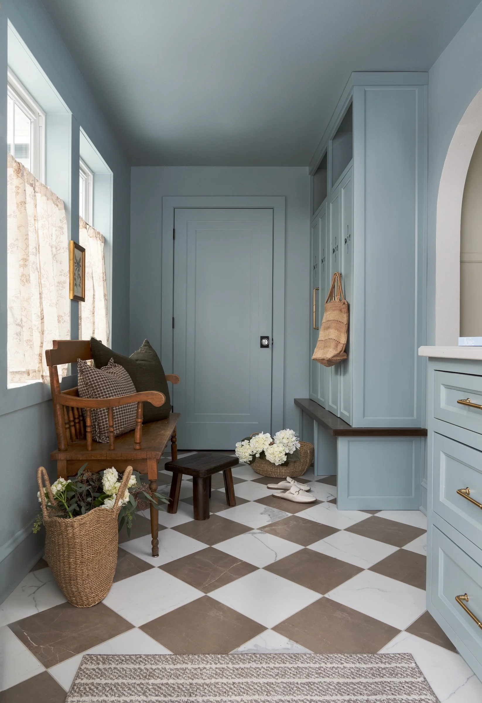 Whitefish Bay Tudor mudroom with custom built in storage and tiled floor