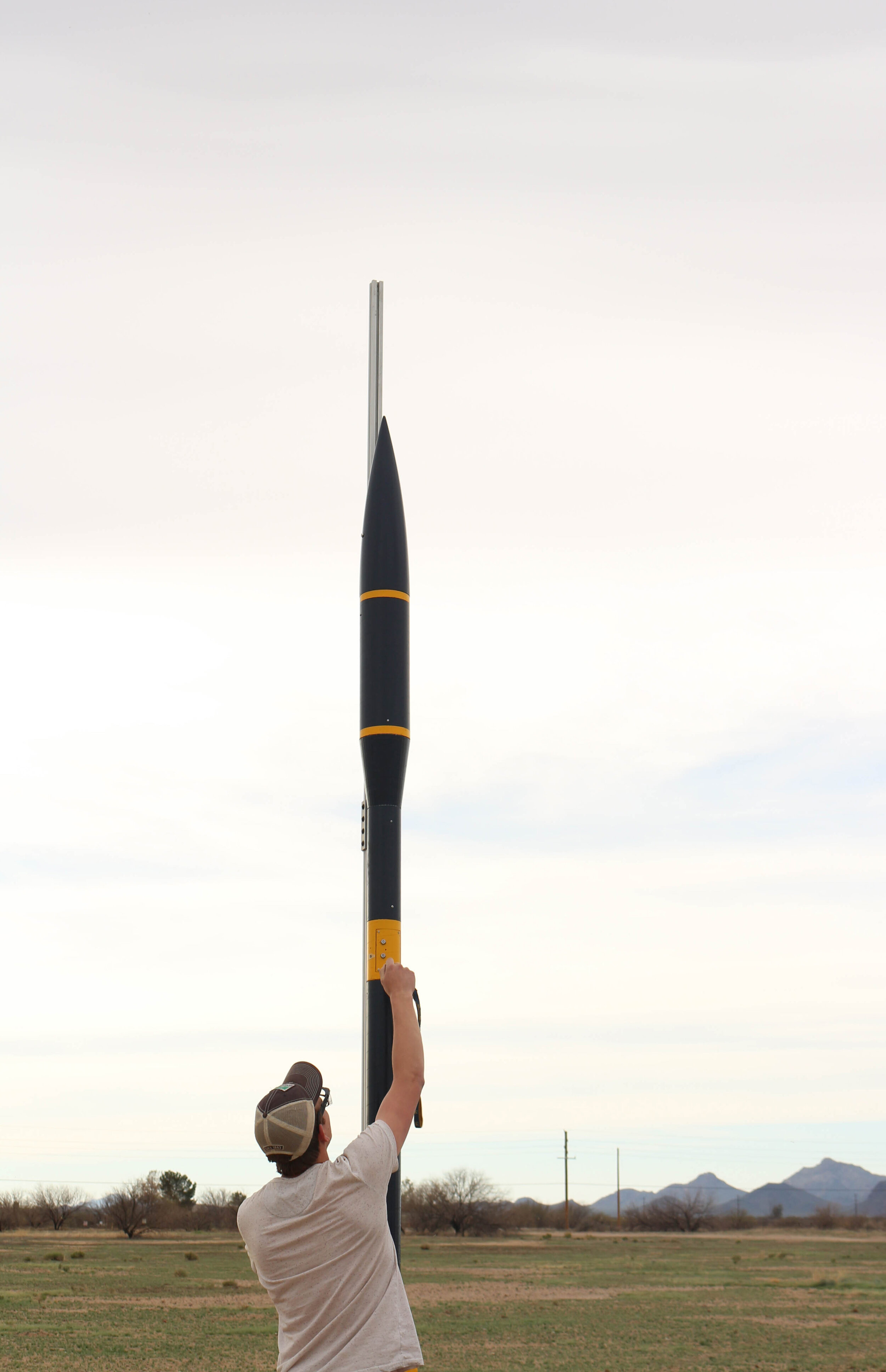 A photo of me arming the black power charges used to separate the rocket at apogee