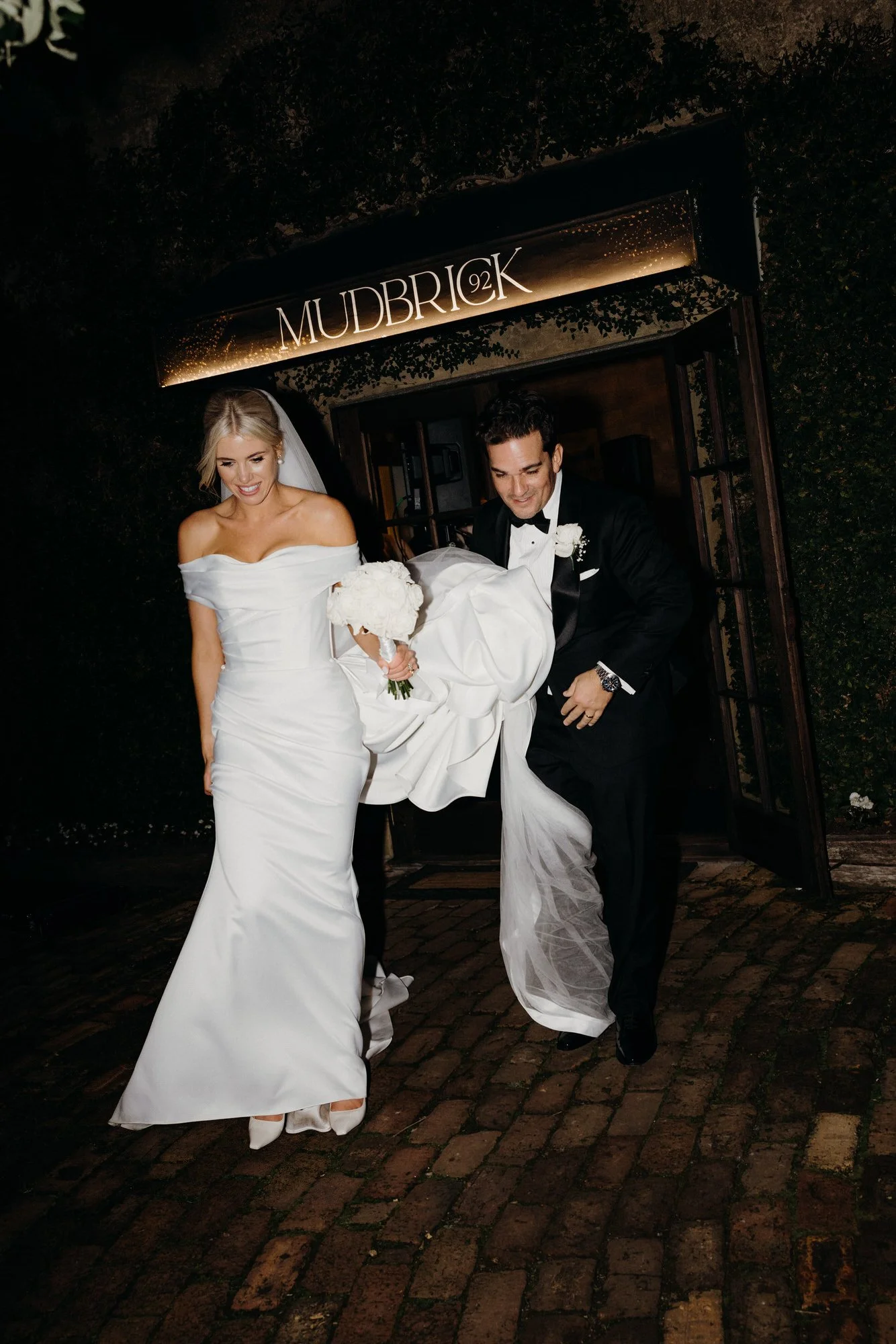 Bride and Groom walking together at Mudbrick on Waiheke Island