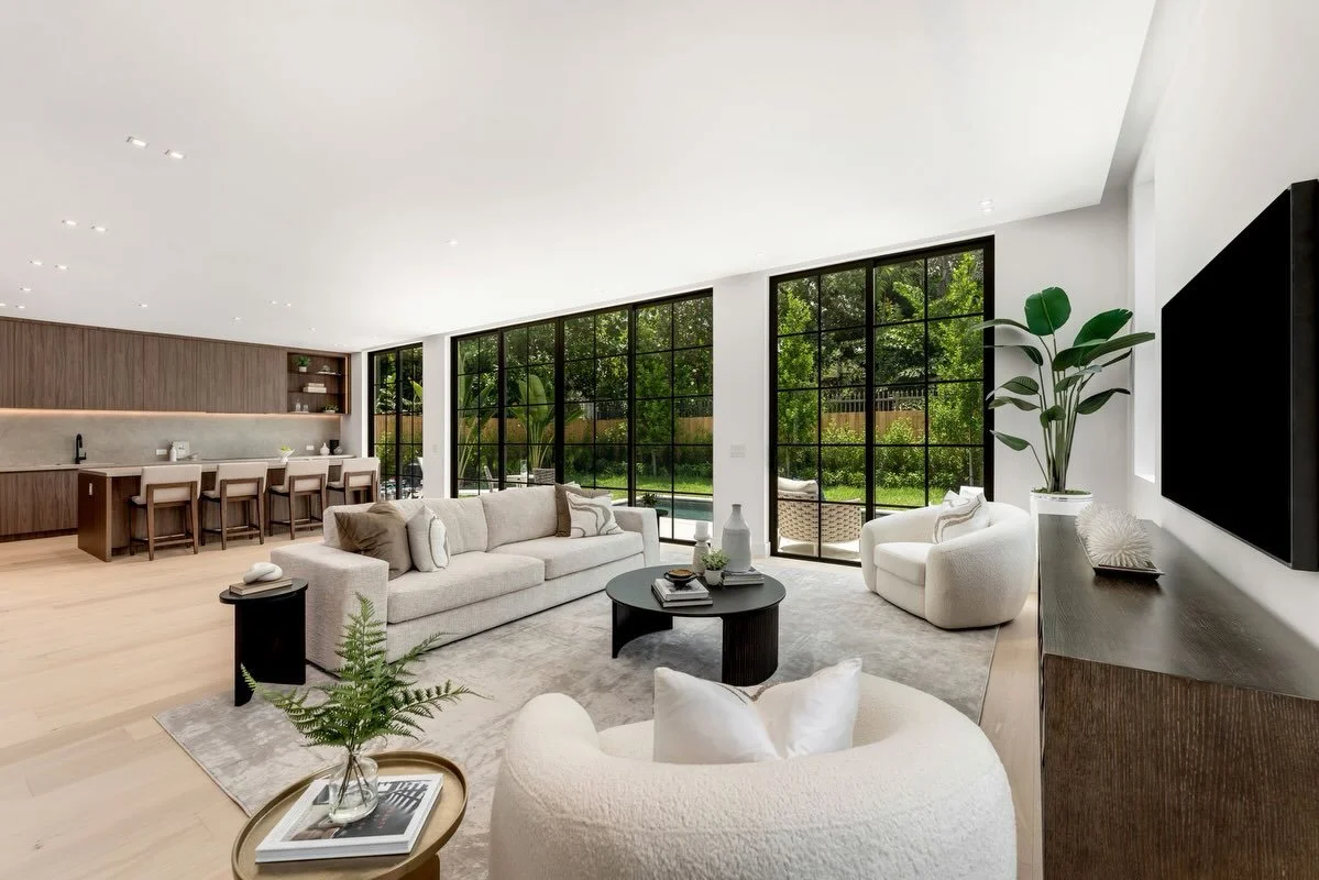 Inside 3352 Charles Avenue.

Warm walnut cabinetry, pale oak floors and a restrained natural palette bring softness to the home&rsquo;s clean architectural lines. Expansive black-framed glass opens the kitchen, living and dining spaces to the garden 