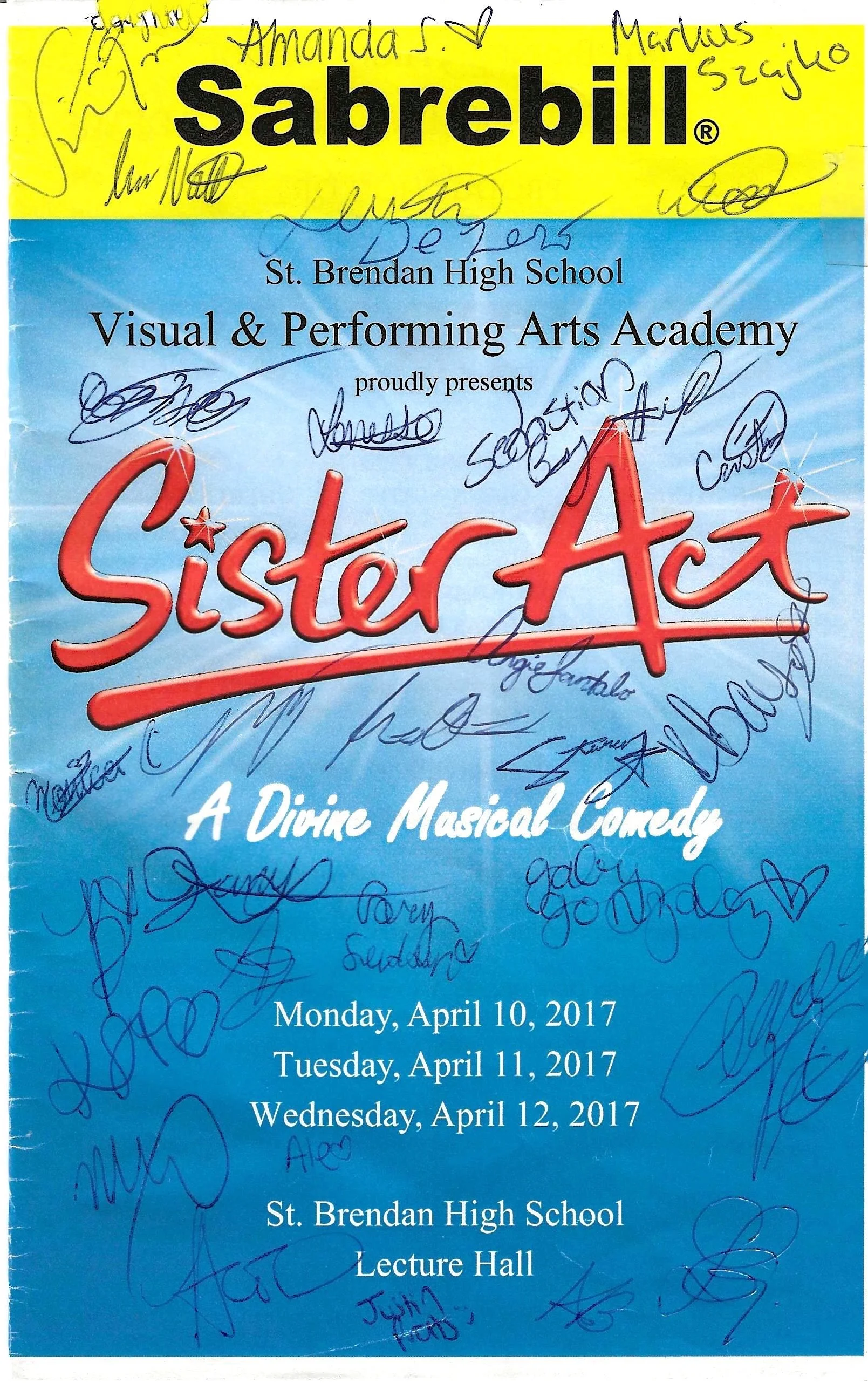 A program cover for Sister Act, a divine musical comedy, performed by St. Brendan High School's Visual & Performing Arts Academy. The cover is blue with signatures in blue ink across it. The performance dates are April 10-12, 2017, at the school’s le
