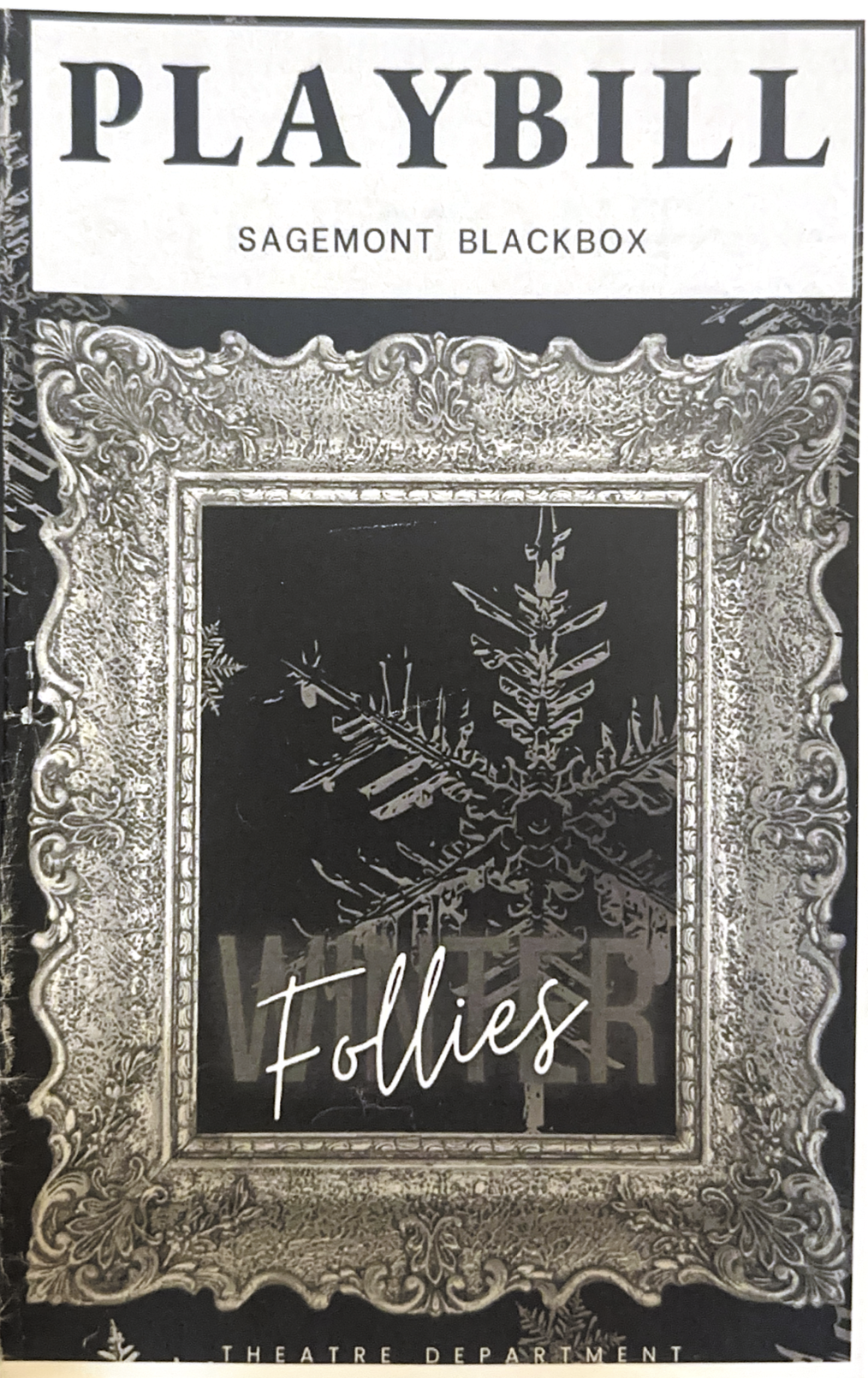 Playbill cover for Sagemont Blackbox featuring a large ornate frame surrounding a black and white image of an intricate snowflake pattern with the word 'Follies' written in cursive in front.