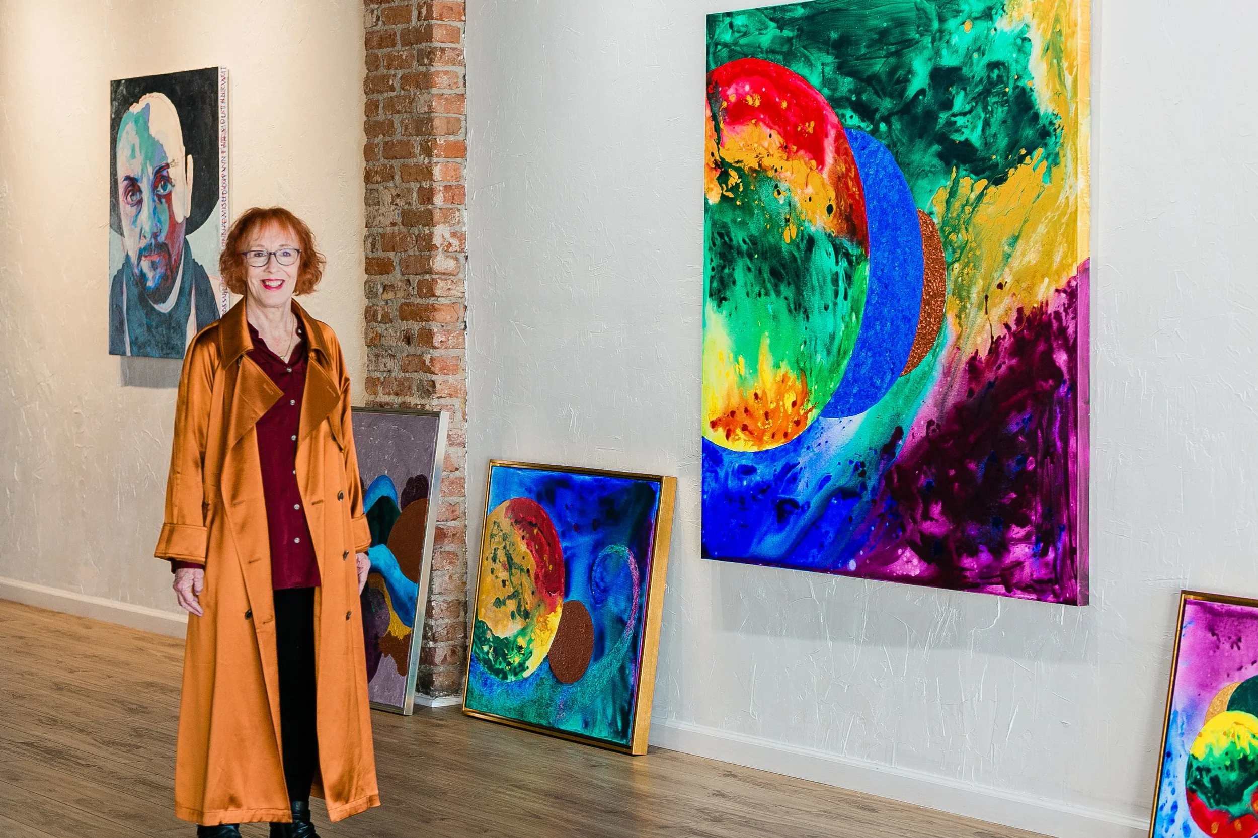 Owner of the Savage Mystic Gallery, Morgan Moffat with her paintings