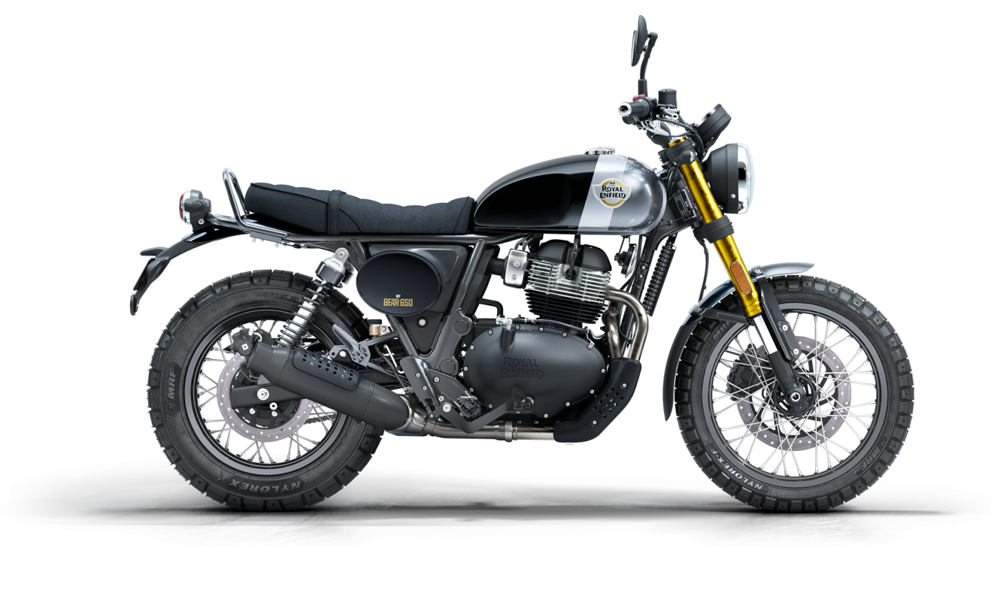 A Royal Enfield motorcycle with a black and silver color scheme, featuring a rugged design, large tires, and a suspension system.