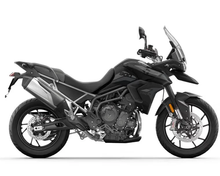 Black adventure motorcycle with a windshield, dual disc brakes, and off-road tires.
