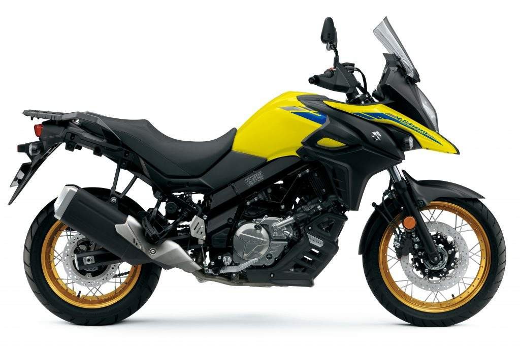 Yellow and black Suzuki adventure motorcycle with gold wheels, windshield, and front disc brake.