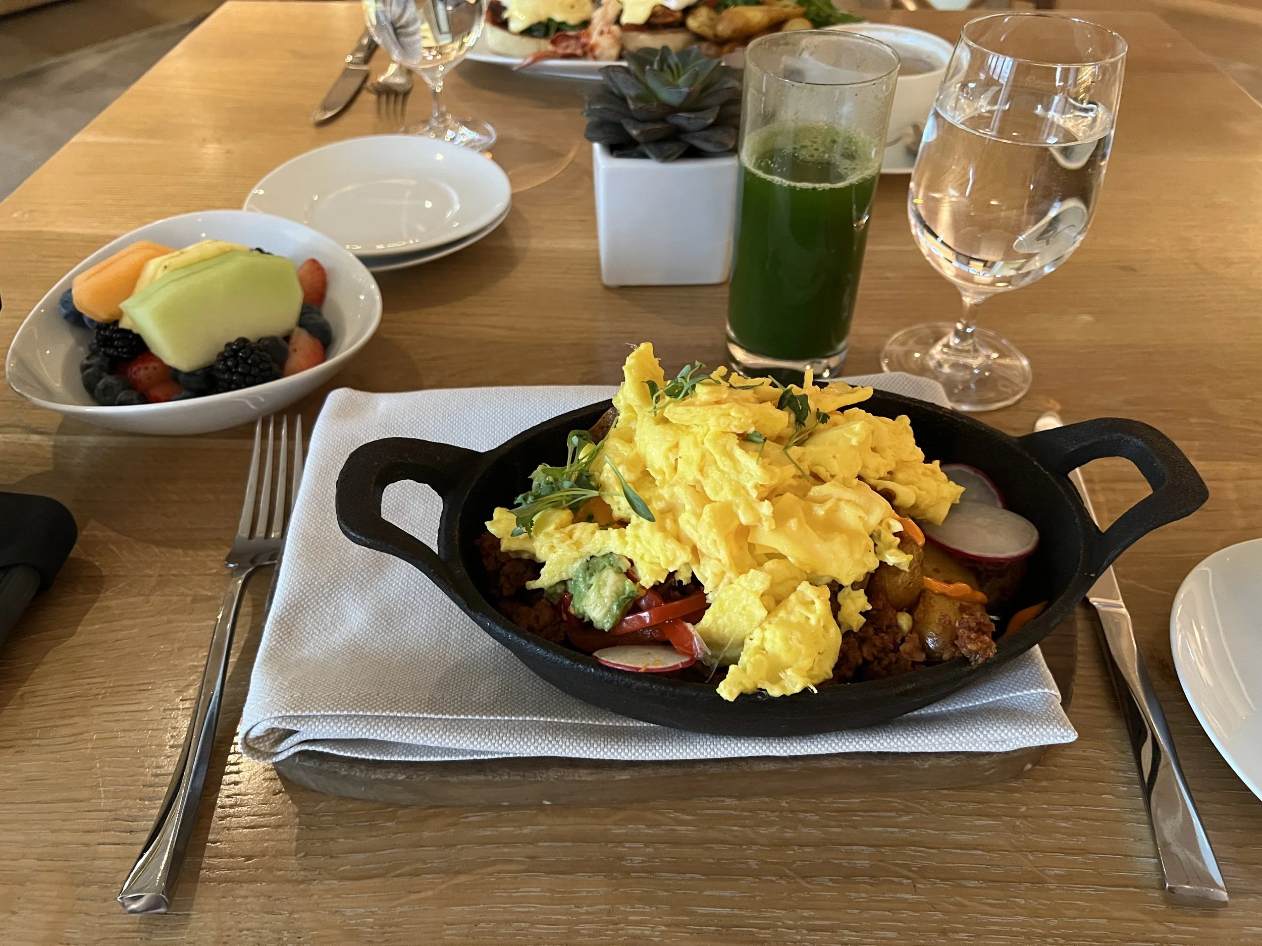 "Wabash" breakfast set ($39): Chorizo Skillet ($19) and a Green Juice ($9) with accompanying fruit bowl, pastry basket, and coffee.