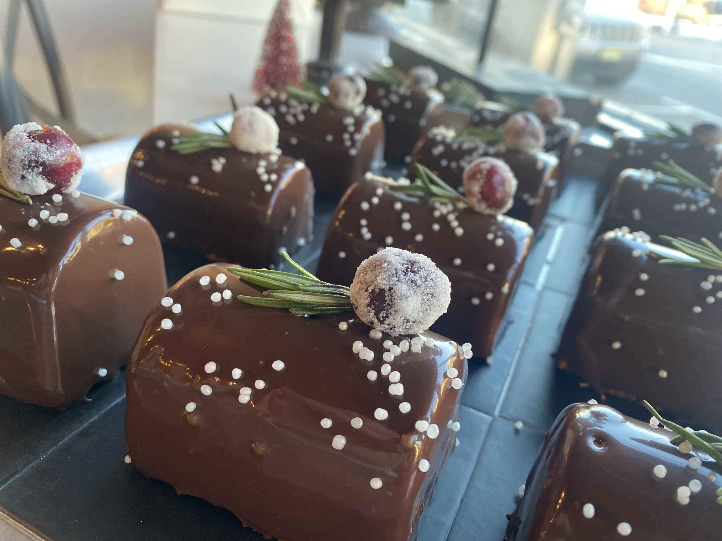 Mini size Black Forest Yule Log: Layers of moist chocolate biscuit, Belgian dark chocolate mousse, brandied cherries, and fresh vanilla beans flavored Chantilly.
Mini size serves 1-2.  $15.00
Available for pick up starting Tuesday December 16th.
