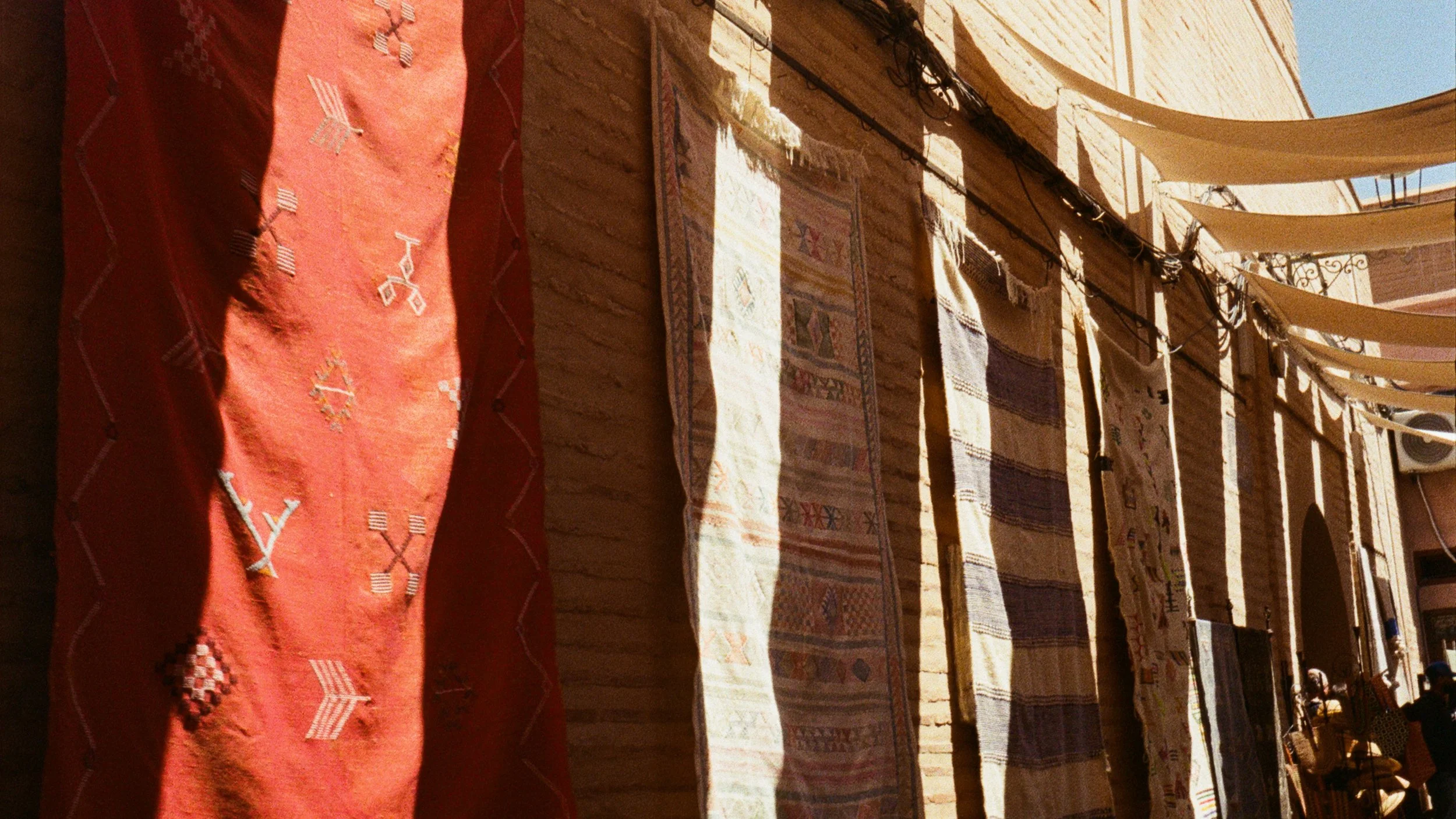 Clothes hanging on a clothesline outside a brick building.