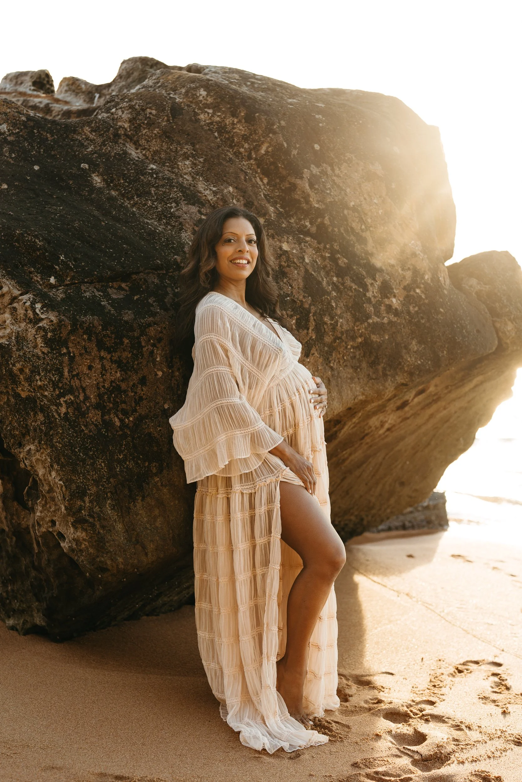 pregnant woman in beautiful maternity gown during a maternity photography session at the beach in Sydney