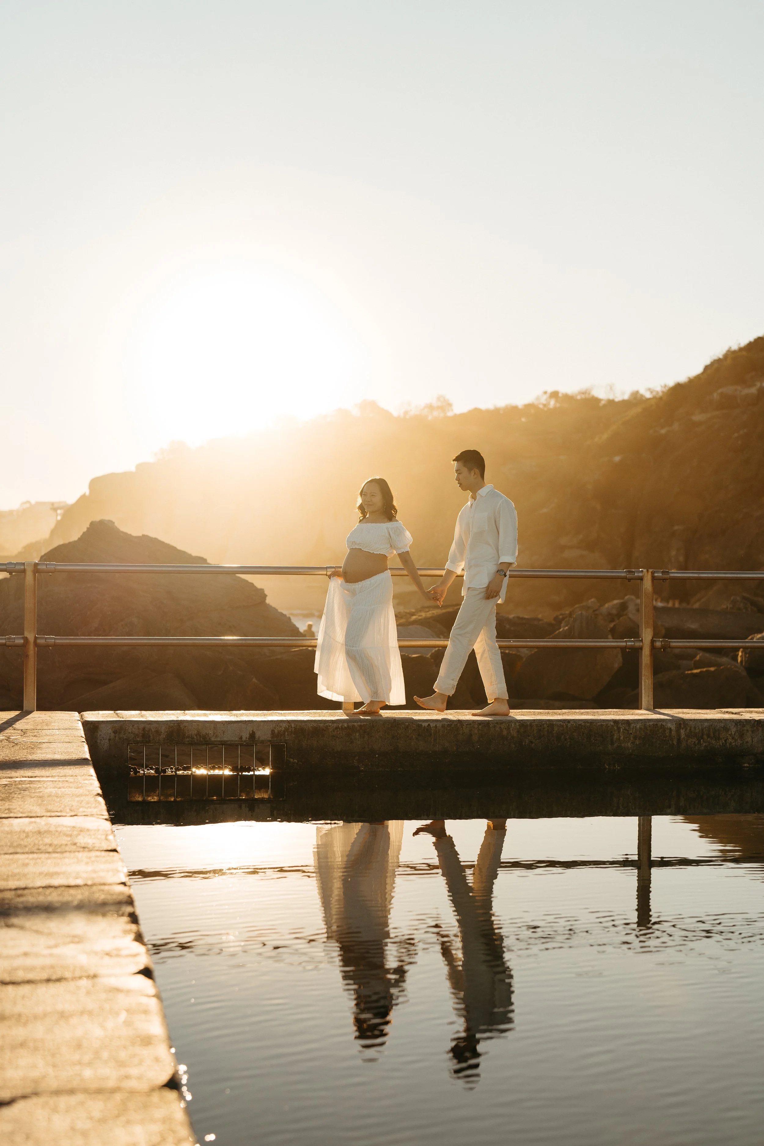 Pregnant woman and her husband at a maternity photography session at Curl Curl beach in Sydney