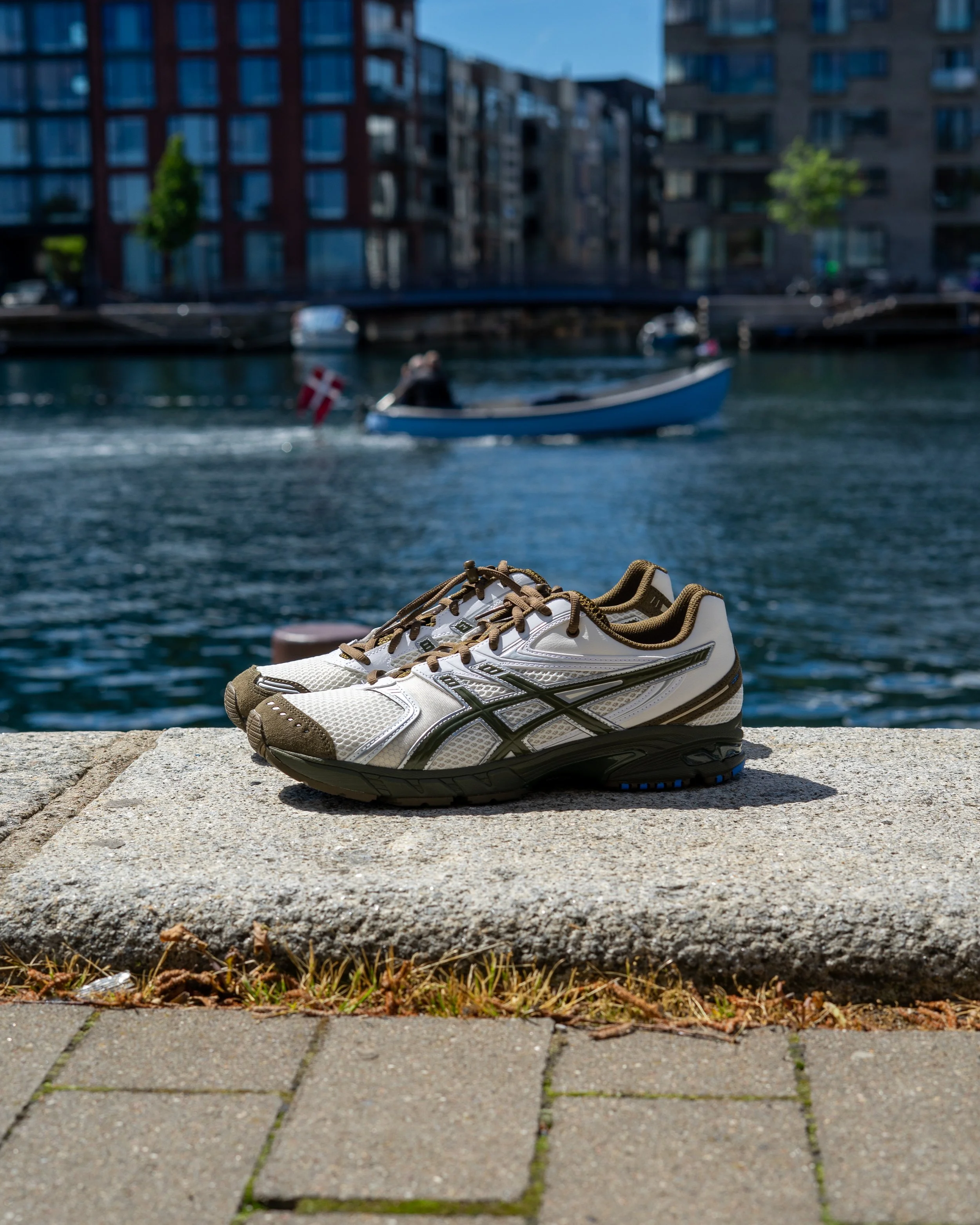 A pair of ASICS and VacationTempation sneakers in front of the canals of Copenhagen, Denmark