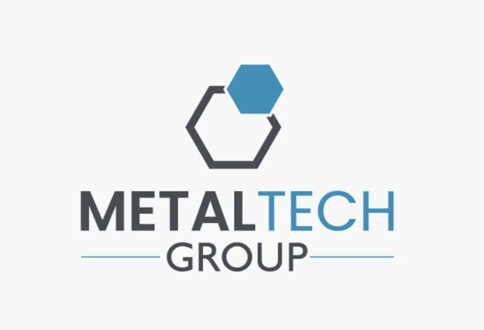 Logo of MetalTech Group featuring a stylized hexagon with a smaller blue hexagon above and the company name in black and blue text.