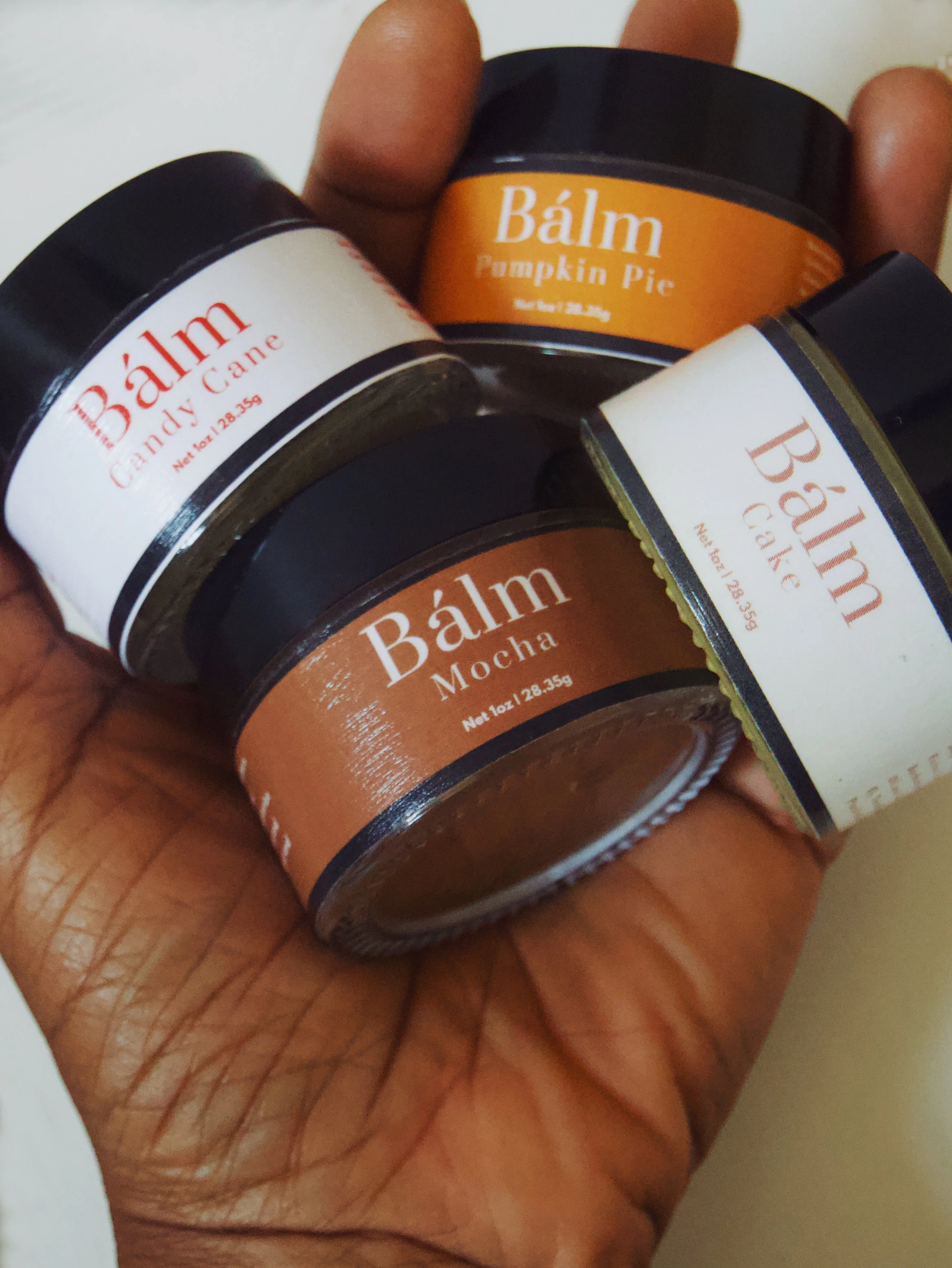 4 balms in hand.jpg