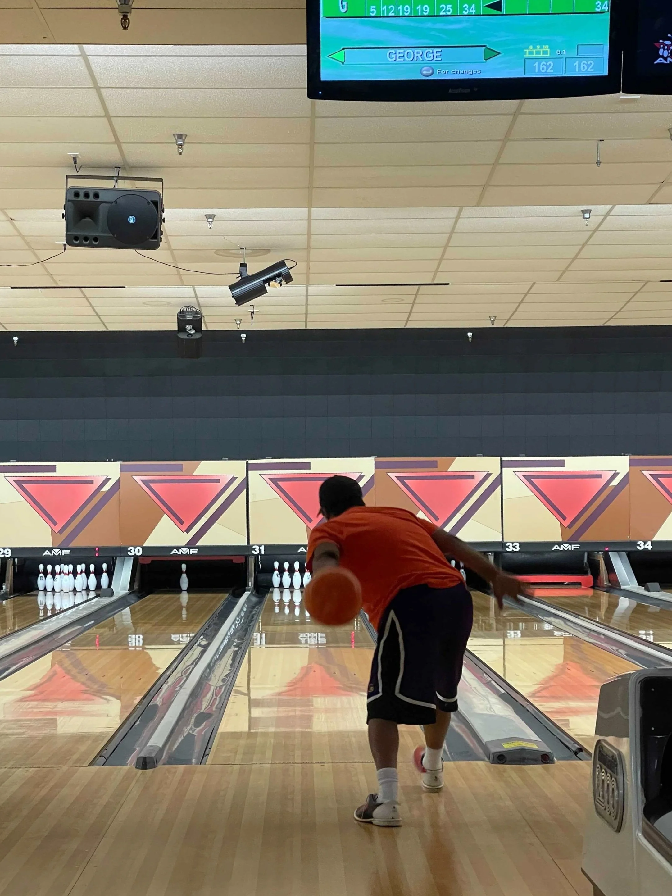 Person throwing a bowling ball down the lane