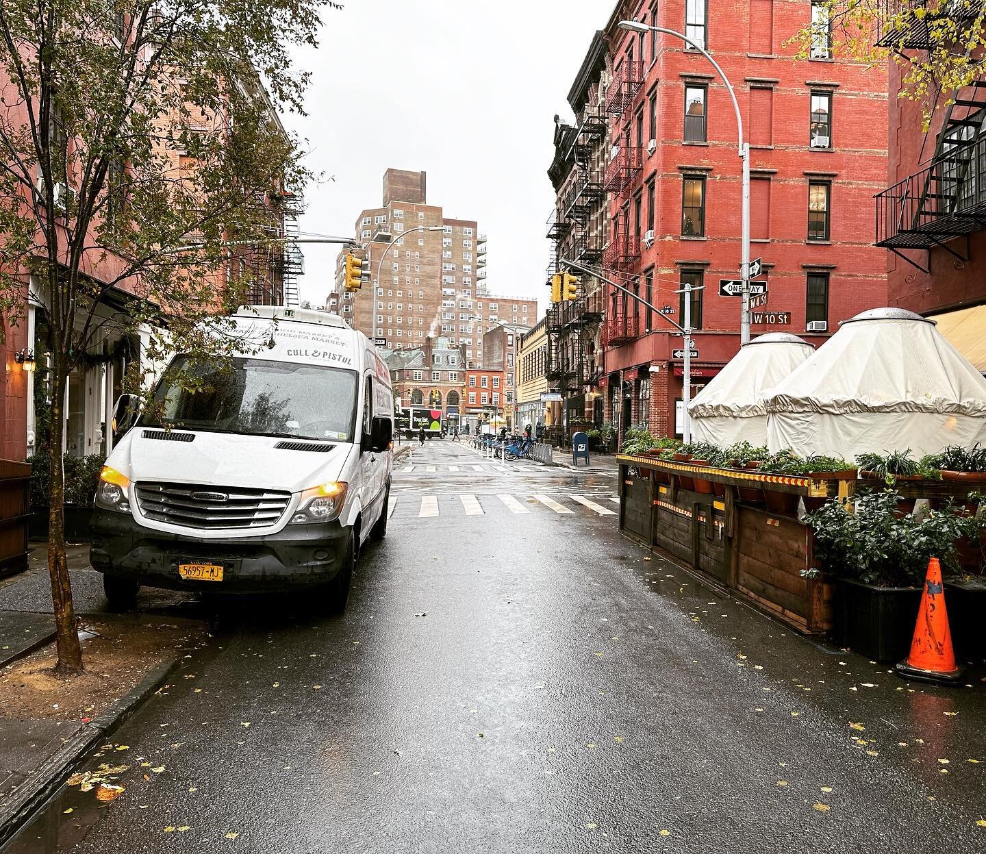 A restaurant food delivery truck parked on the sidewalk because ...yes ... the restaurant's guttershed is parked in the truck loading zone.

If not on the sidewalk, the truck driver must block either a) the single traffic lane on West 4th, or b) the 