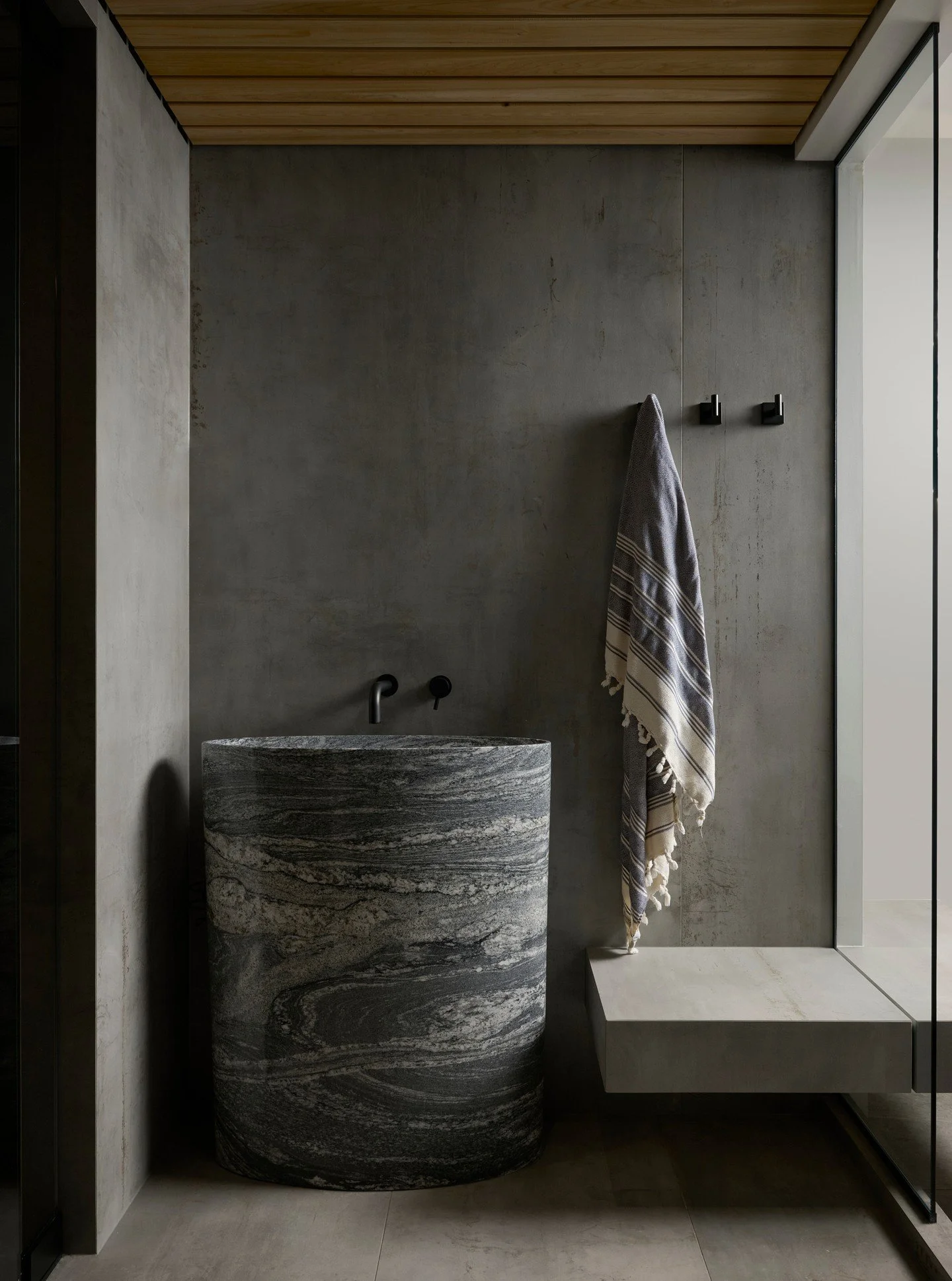 This home spa is my all time favourite creation. The solid marble sink gleams under soft, ambient lighting. The rich texture of cedar wood on the ceiling not only adds visual warmth but also fills the air with an incredible aroma, creating a serene a