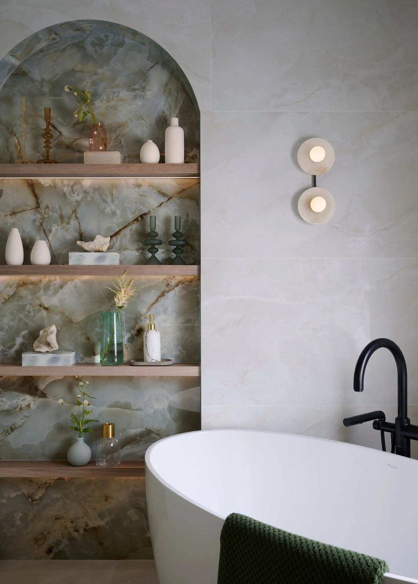 Soft curves and ocean hues 💙&mdash; one of my favorite bathrooms we&rsquo;ve created. An oversized arched niche, wrapped in stunning blue/green tile, perfectly designed to hold all your essentials 🛁 Beautiful and functional. 
*
*
Design: @bluedesig
