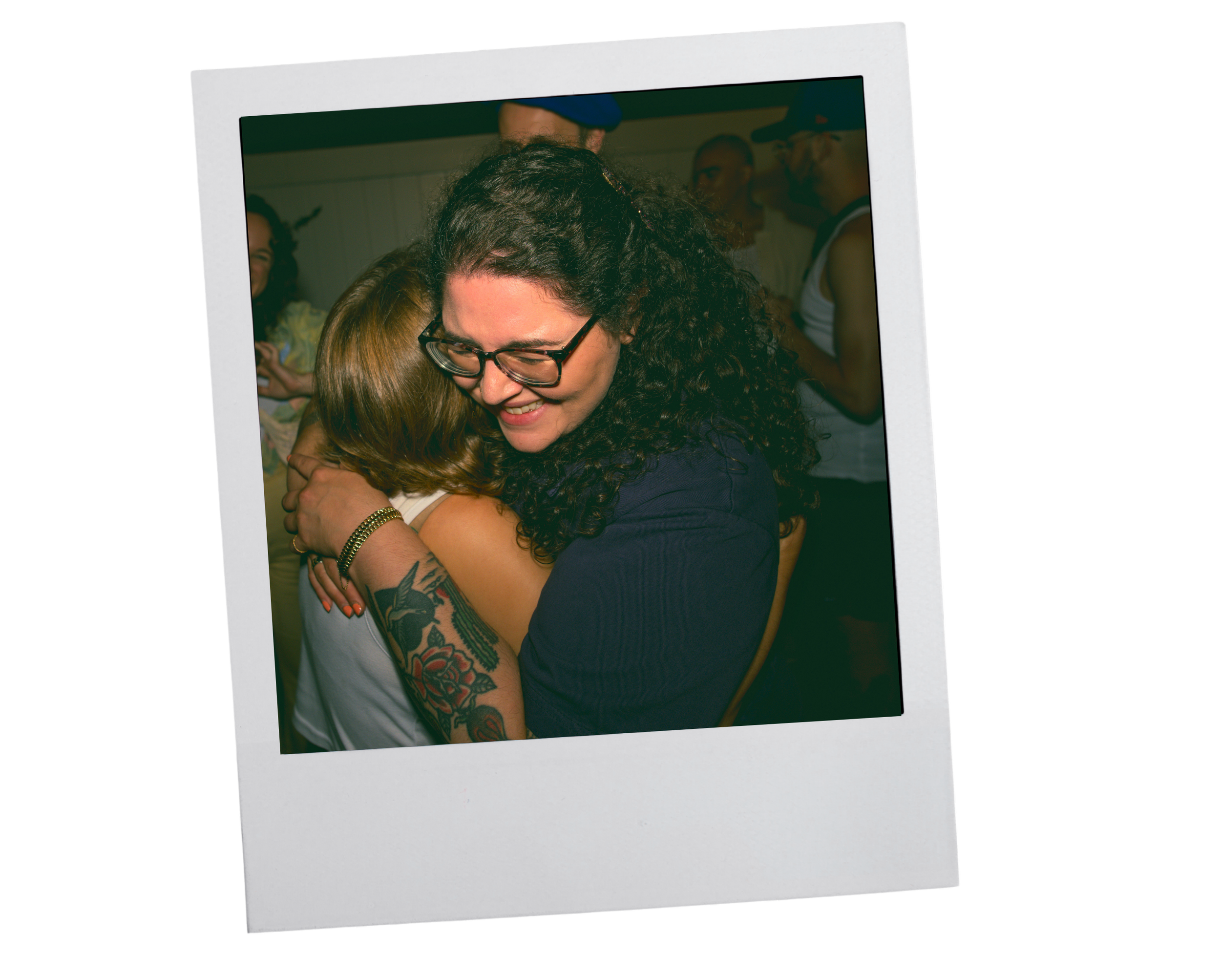 color poloroid of Meryl, somatic intimacy coach, giving a big hug and smiling