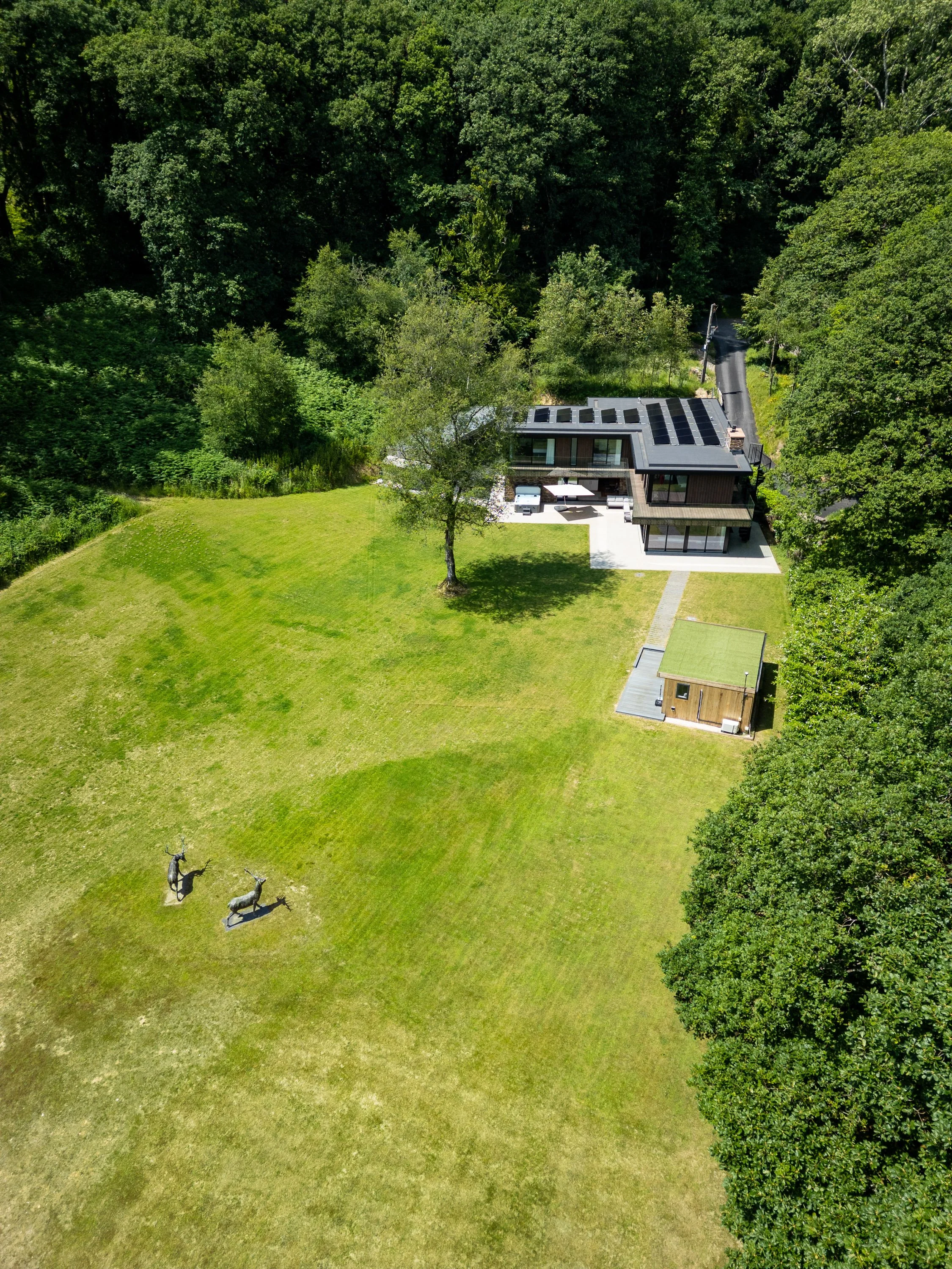 Drone photography close-up of Colwell Wood Cottage near Offwell with solar panels and large garden