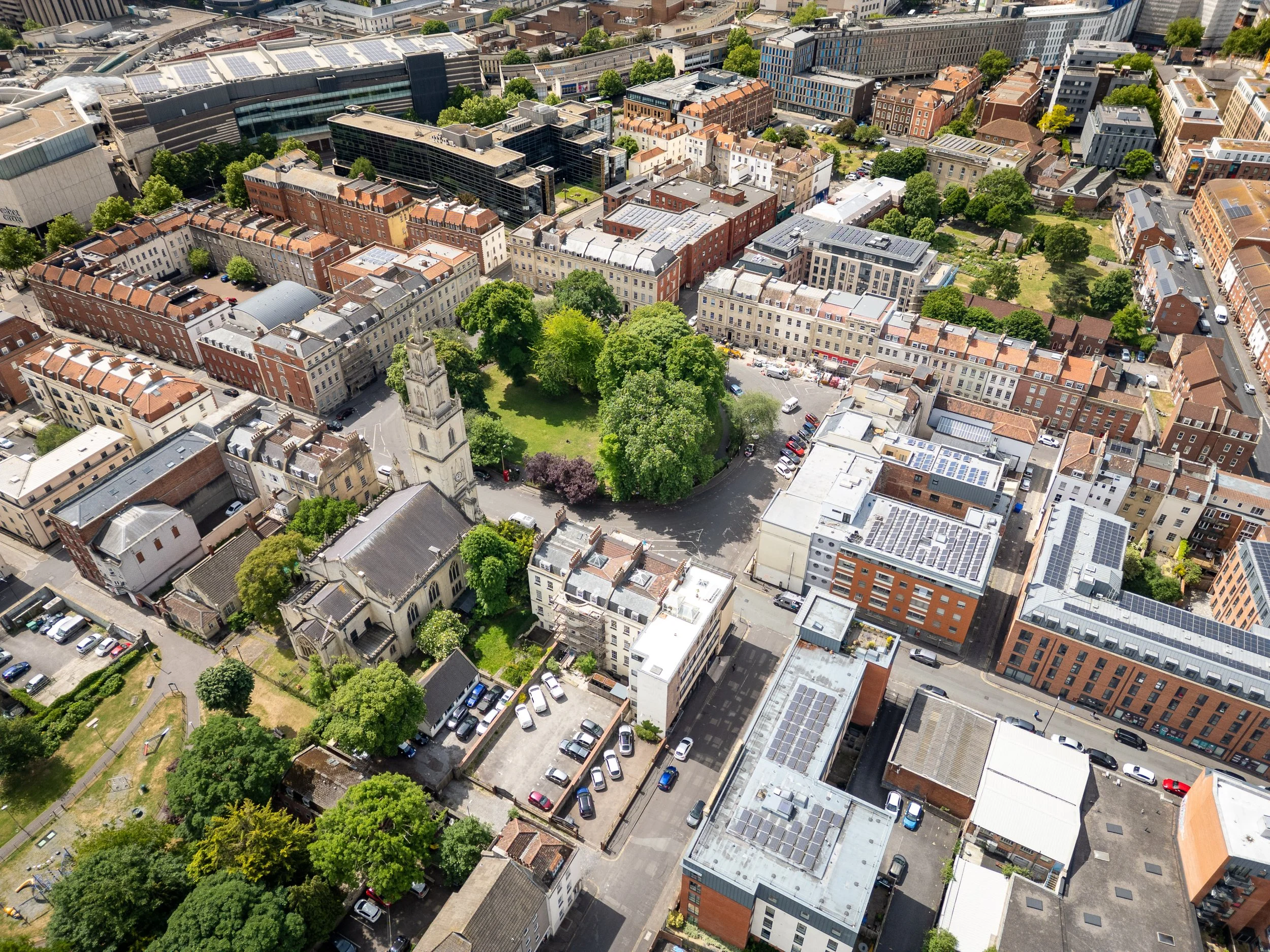 Drone photography of Bristol city centre with historic buildings, church, and rooftops