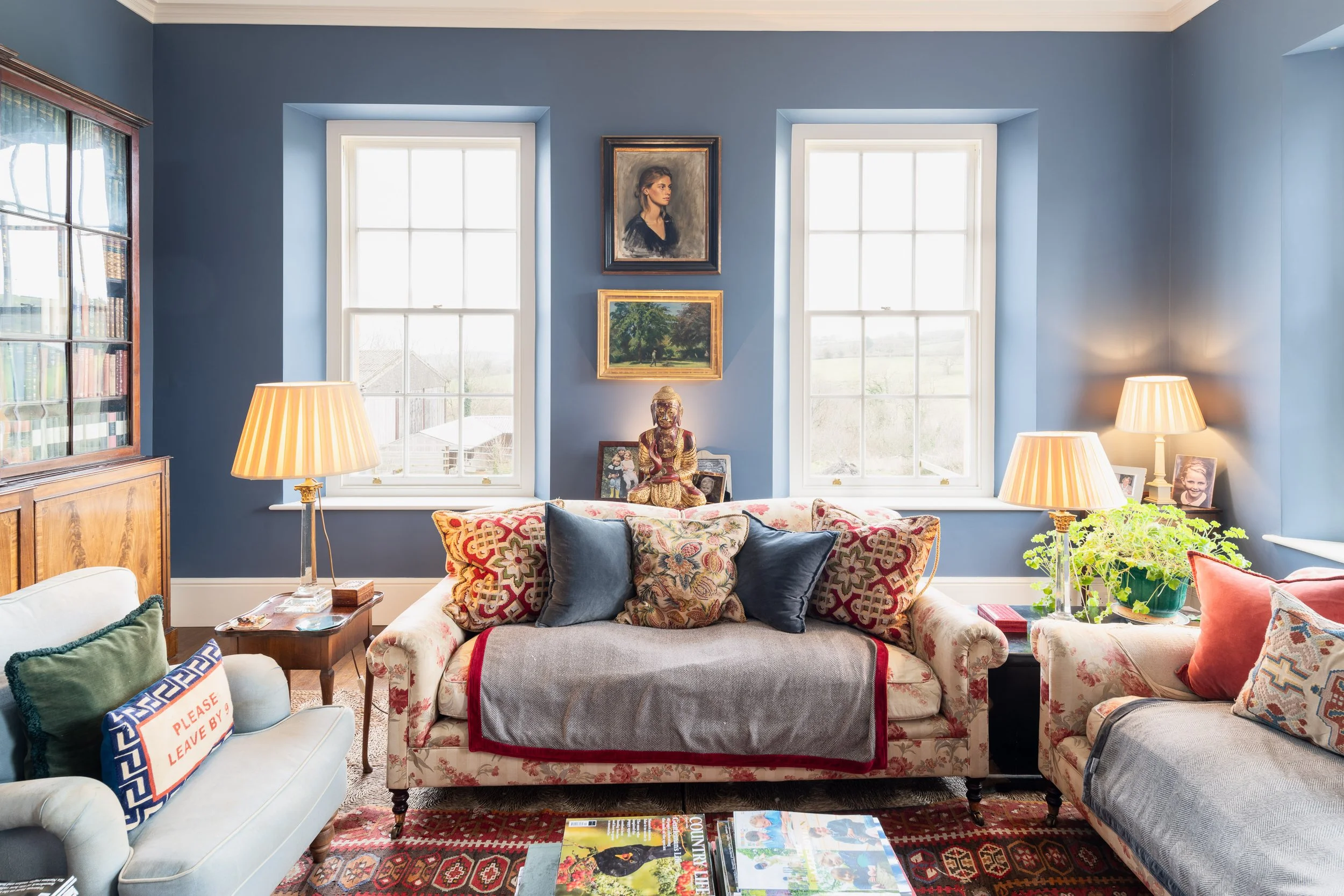 Bright, stylish living room with blue walls, soft furnishings and natural light, captured in a last-minute property photography shoot for estate agents, Airbnb and interior marketing